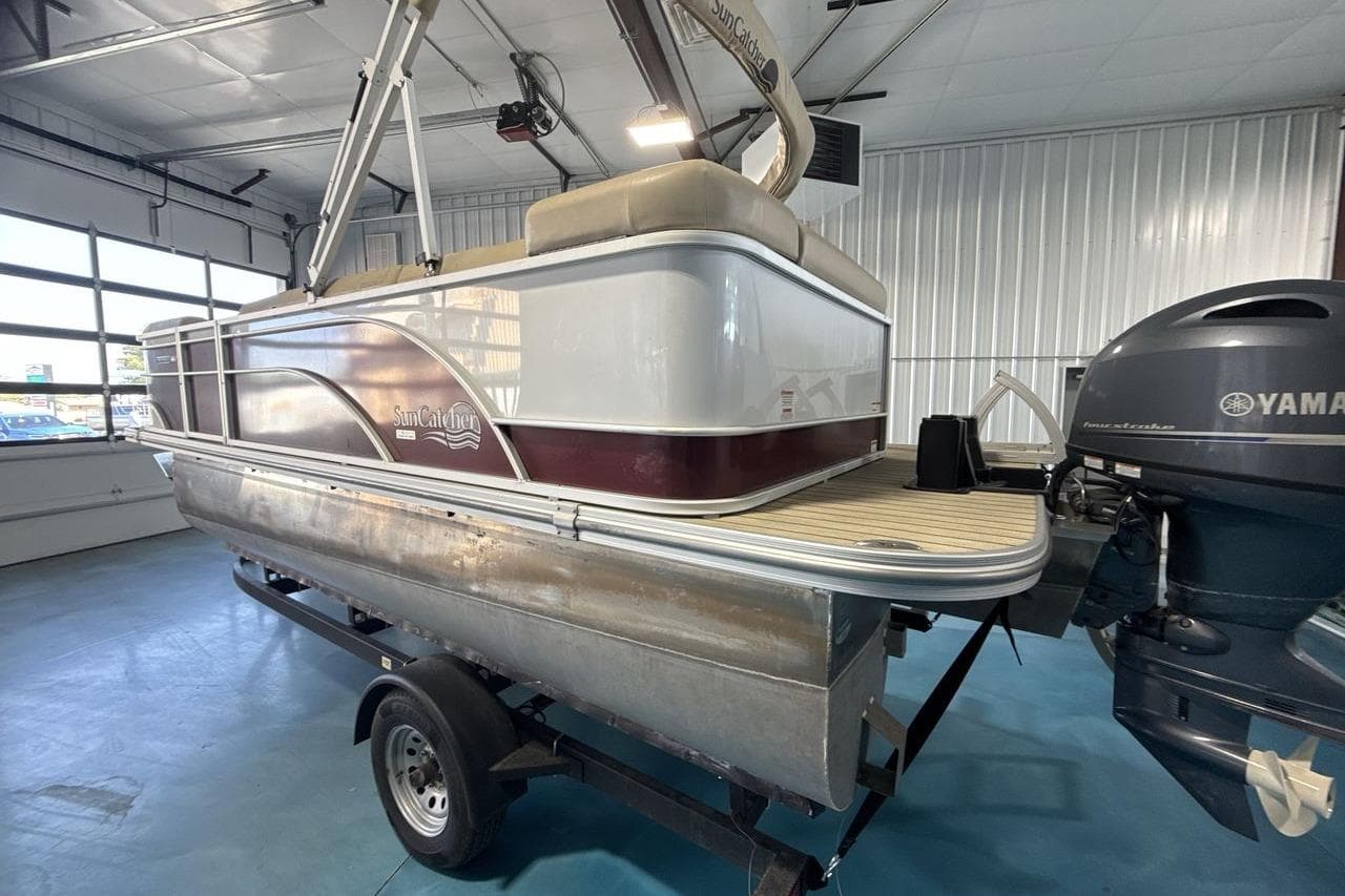 2021 SunCatcher Select 20C pontoon boat with Yamaha motor in a garage setting.