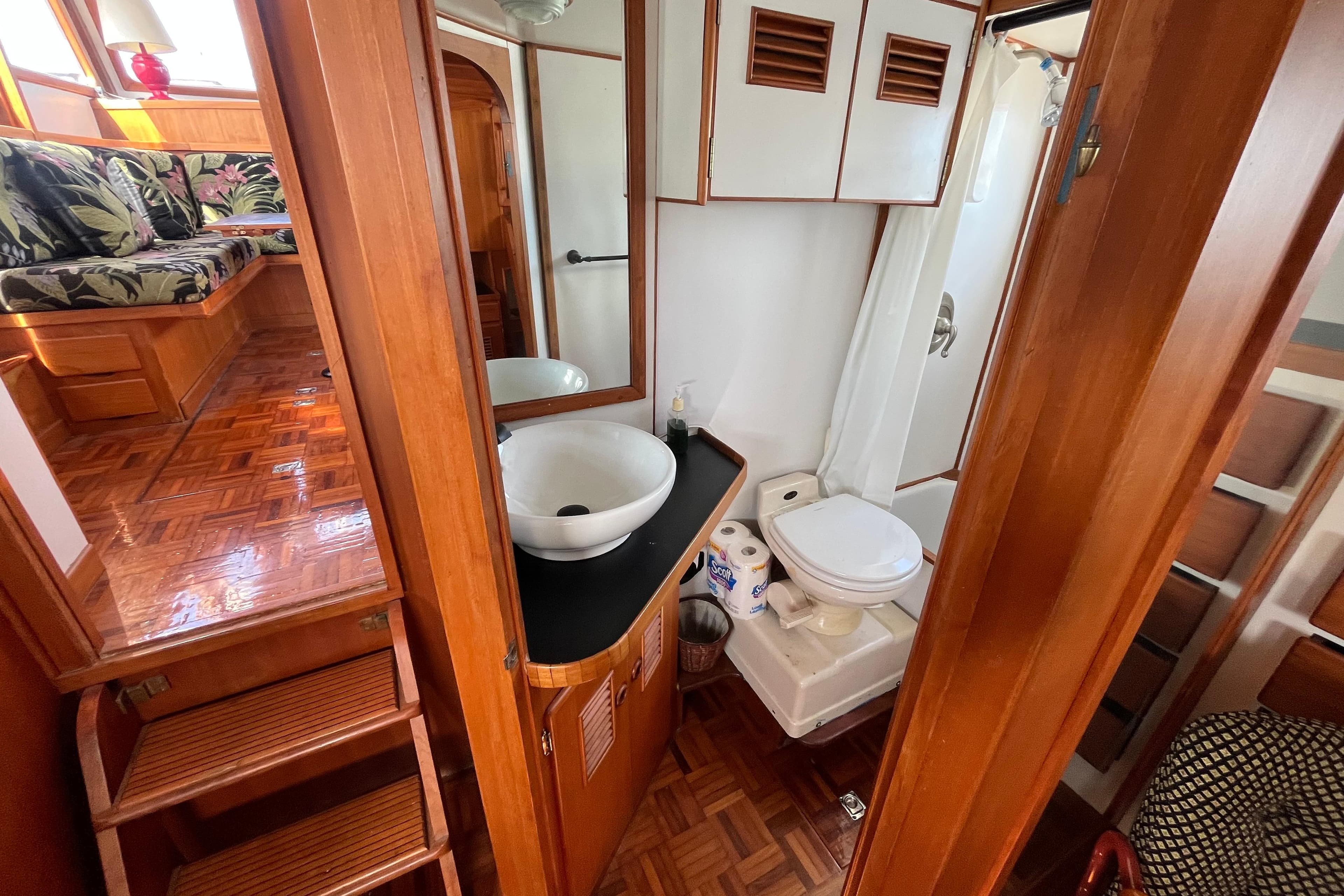 1978 Marine Trader 40 interior with wooden bathroom, sink, and toilet.