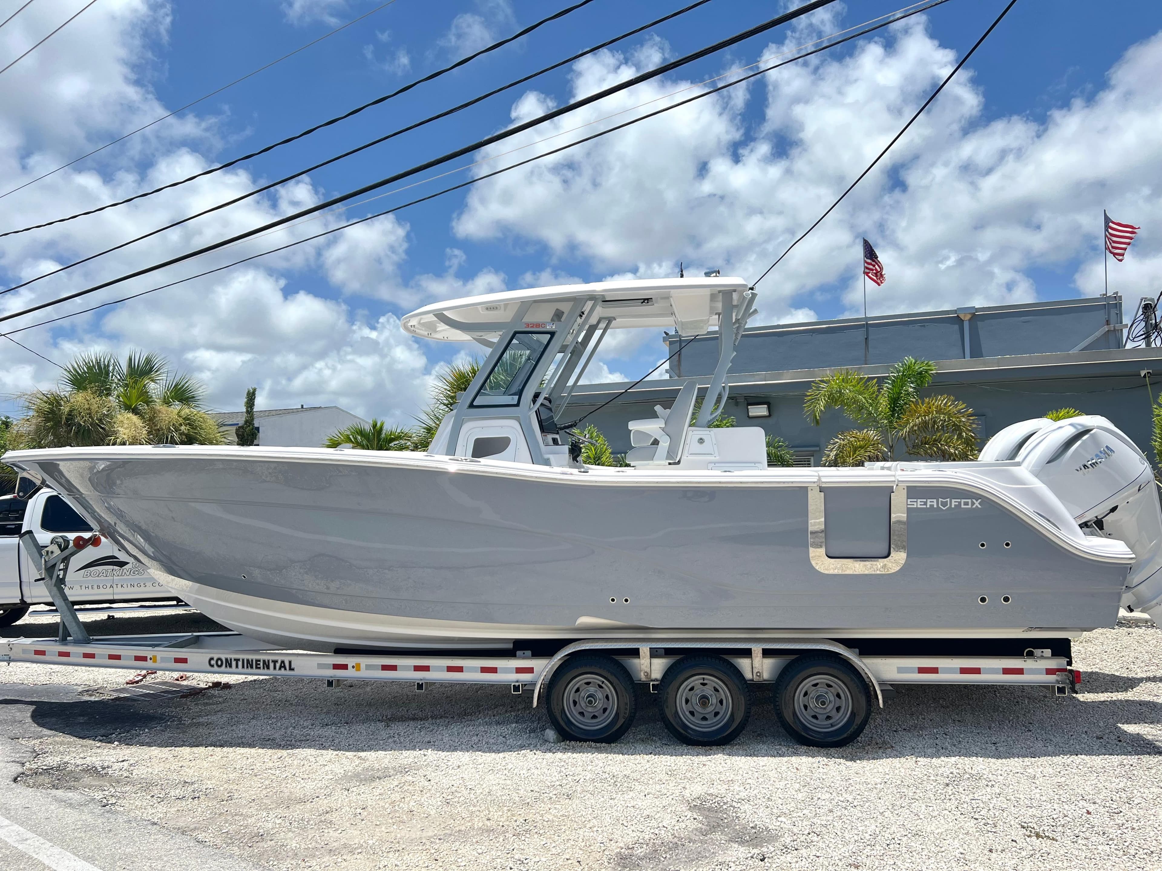 2025 Sea Fox 328 Commander boat on a Continental trailer, parked outdoors.