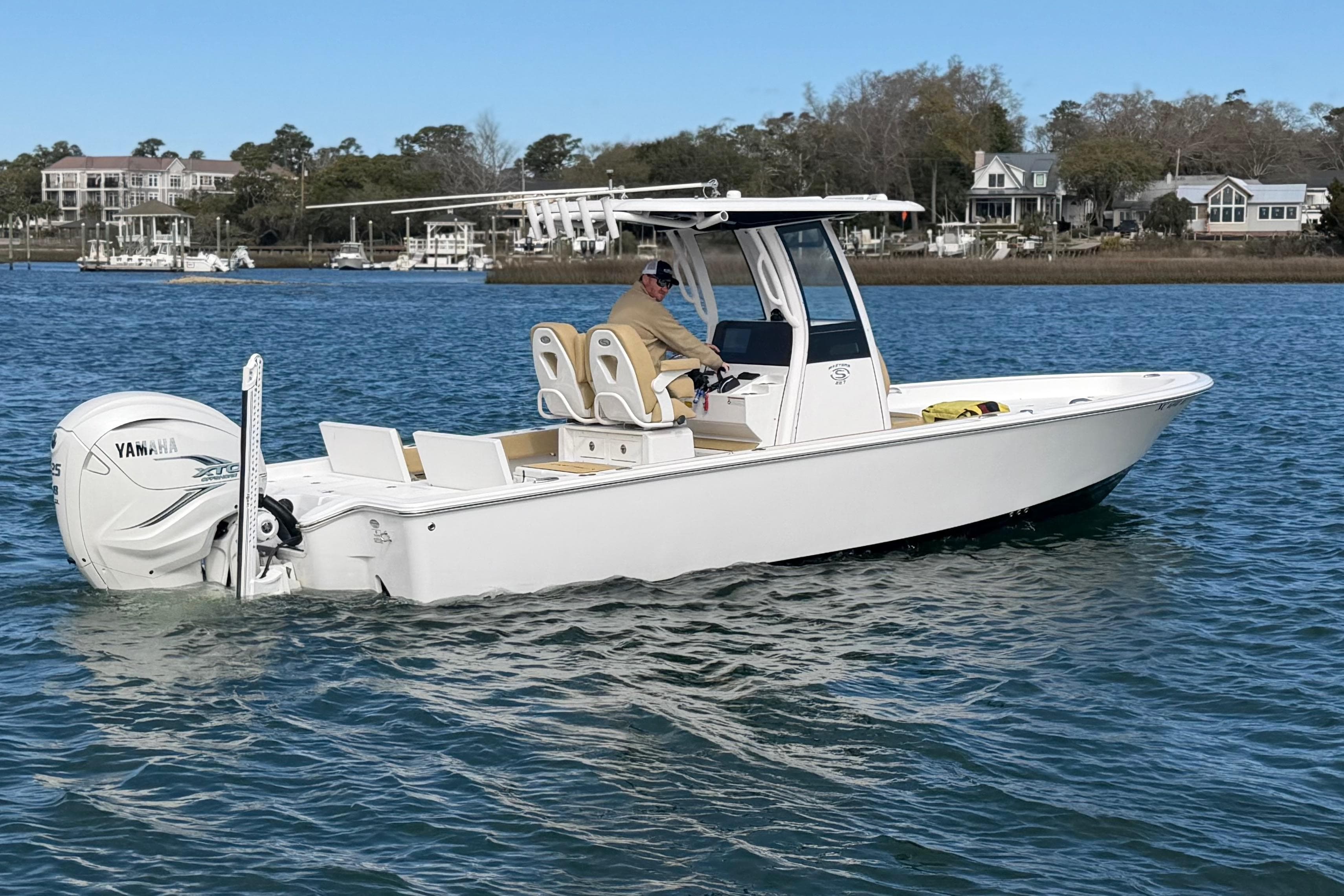 2023 Sportsman Masters 267 Bay Boat cruising on a calm waterway.