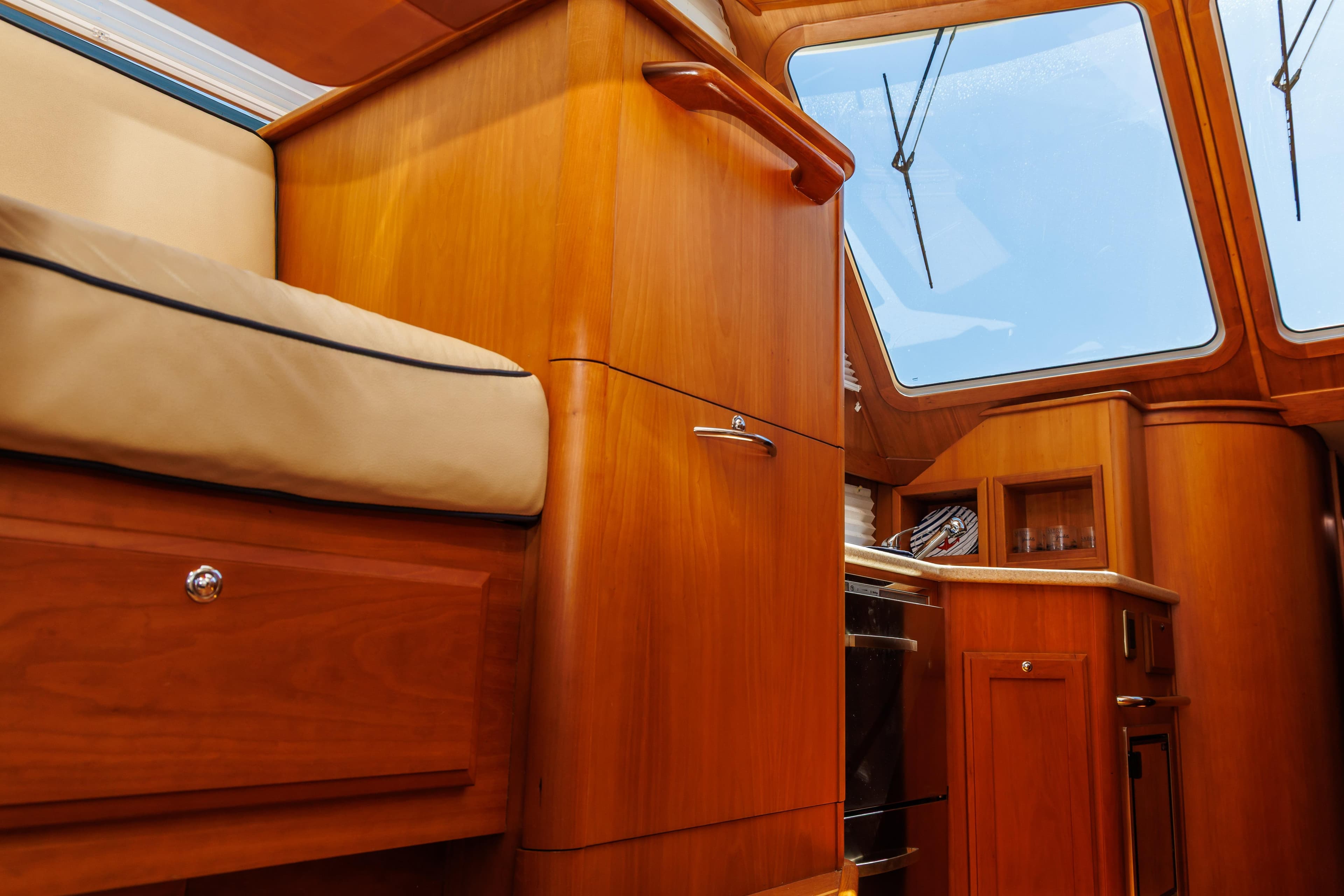 Interior of 2010 Sabre 40 Sedan yacht with wooden cabinetry and seating.