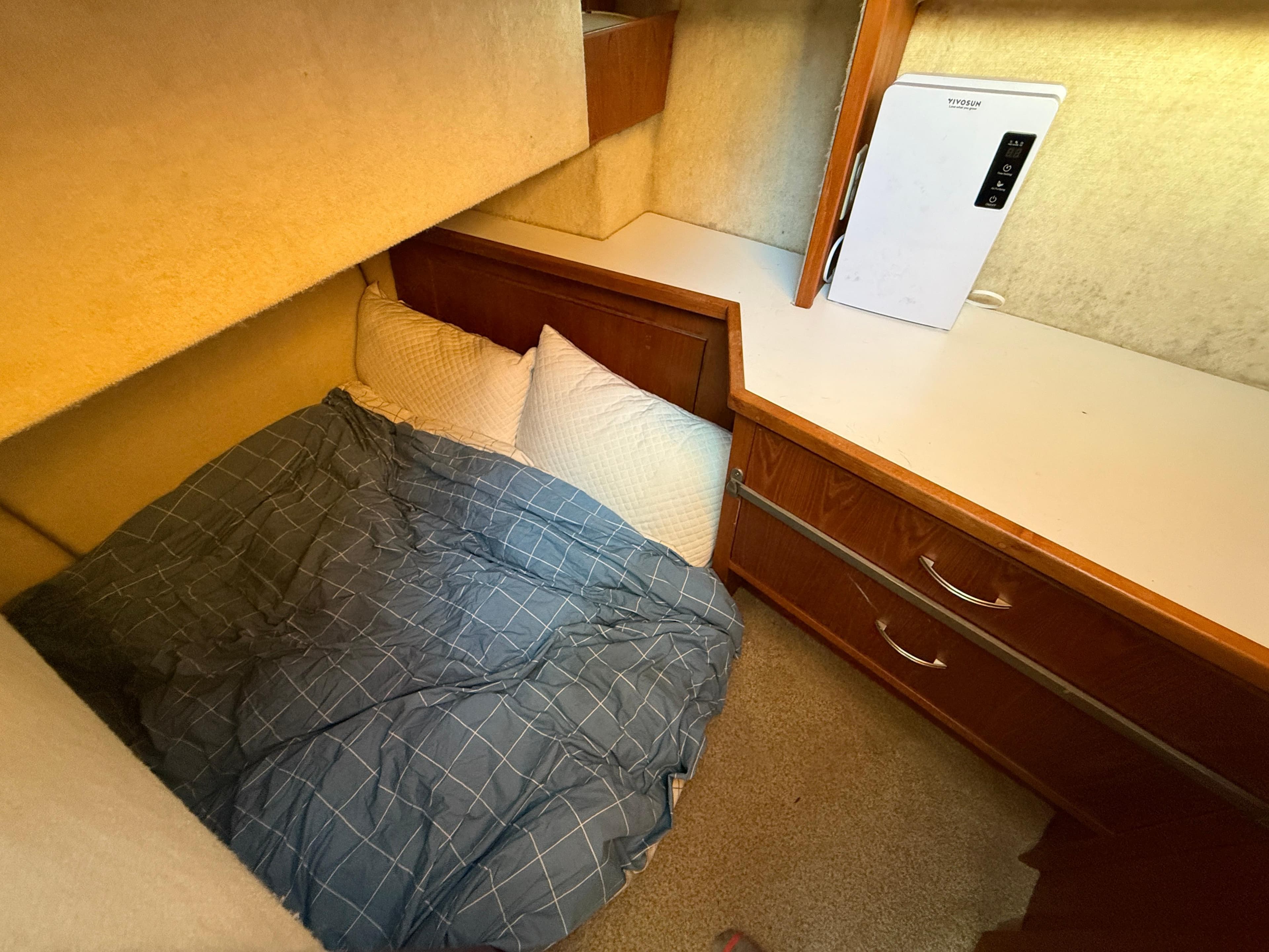 Cozy cabin interior of 1998 Bayliner 4087 Aft Cabin Motoryacht with bed and storage.
