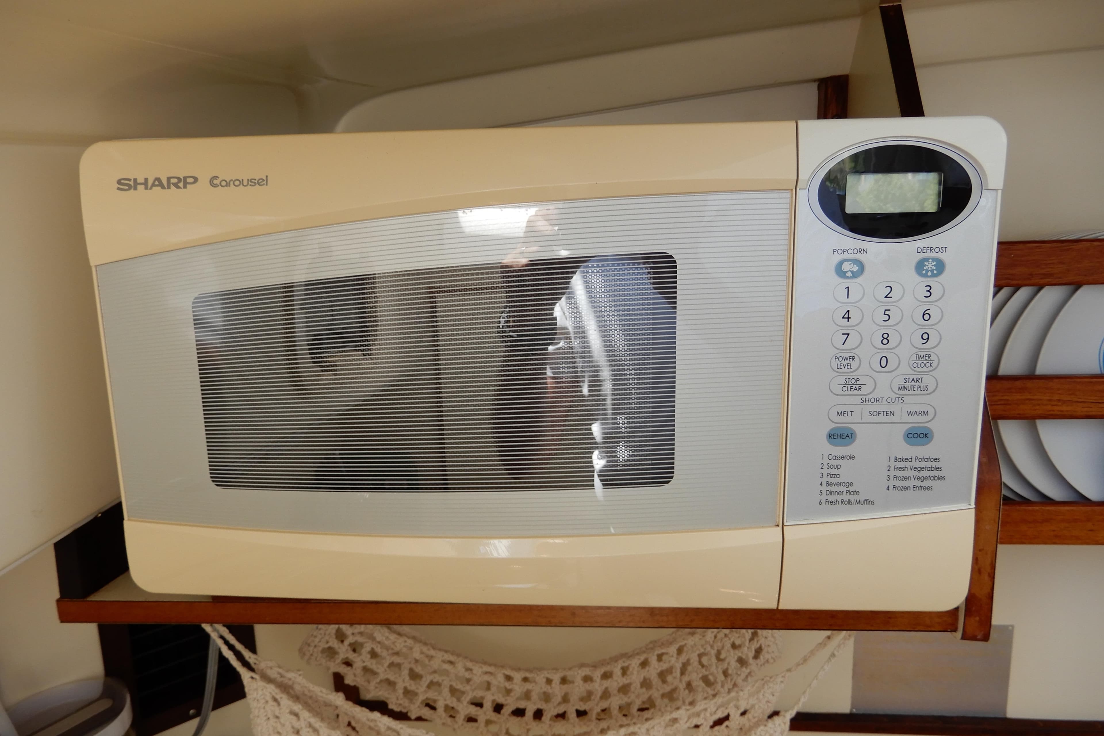 Sharp Carousel microwave inside a 1996 Camano 31 Troll boat kitchen.