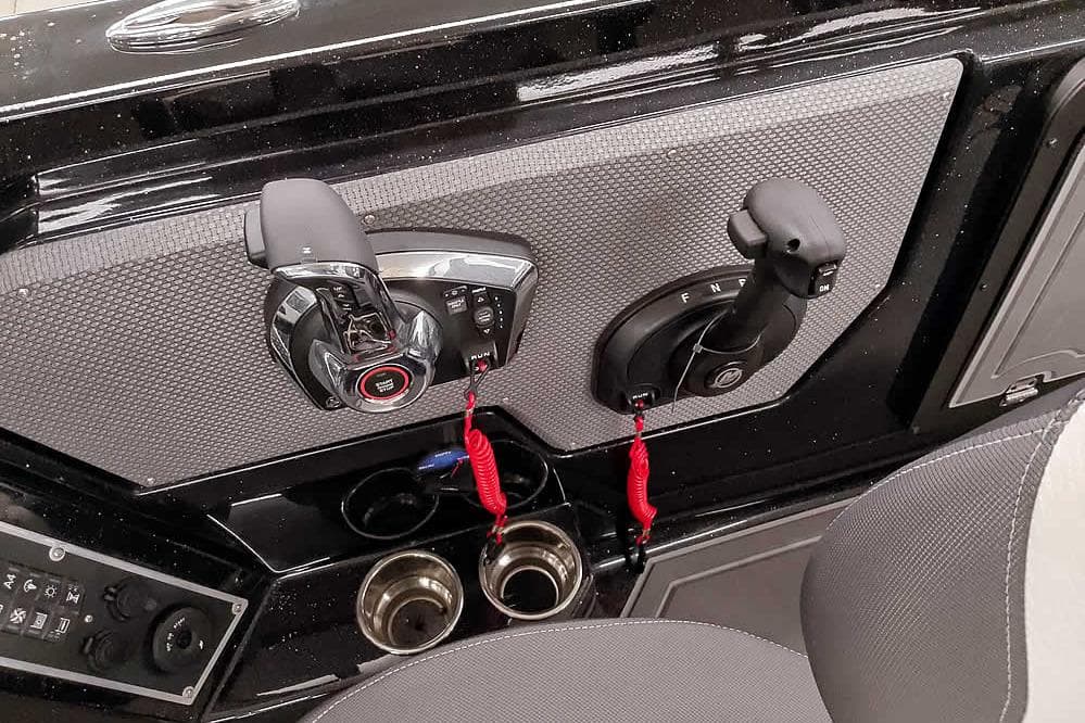 Control panel of 2026 Ranger 620xFS Pro boat with throttle and cup holders.