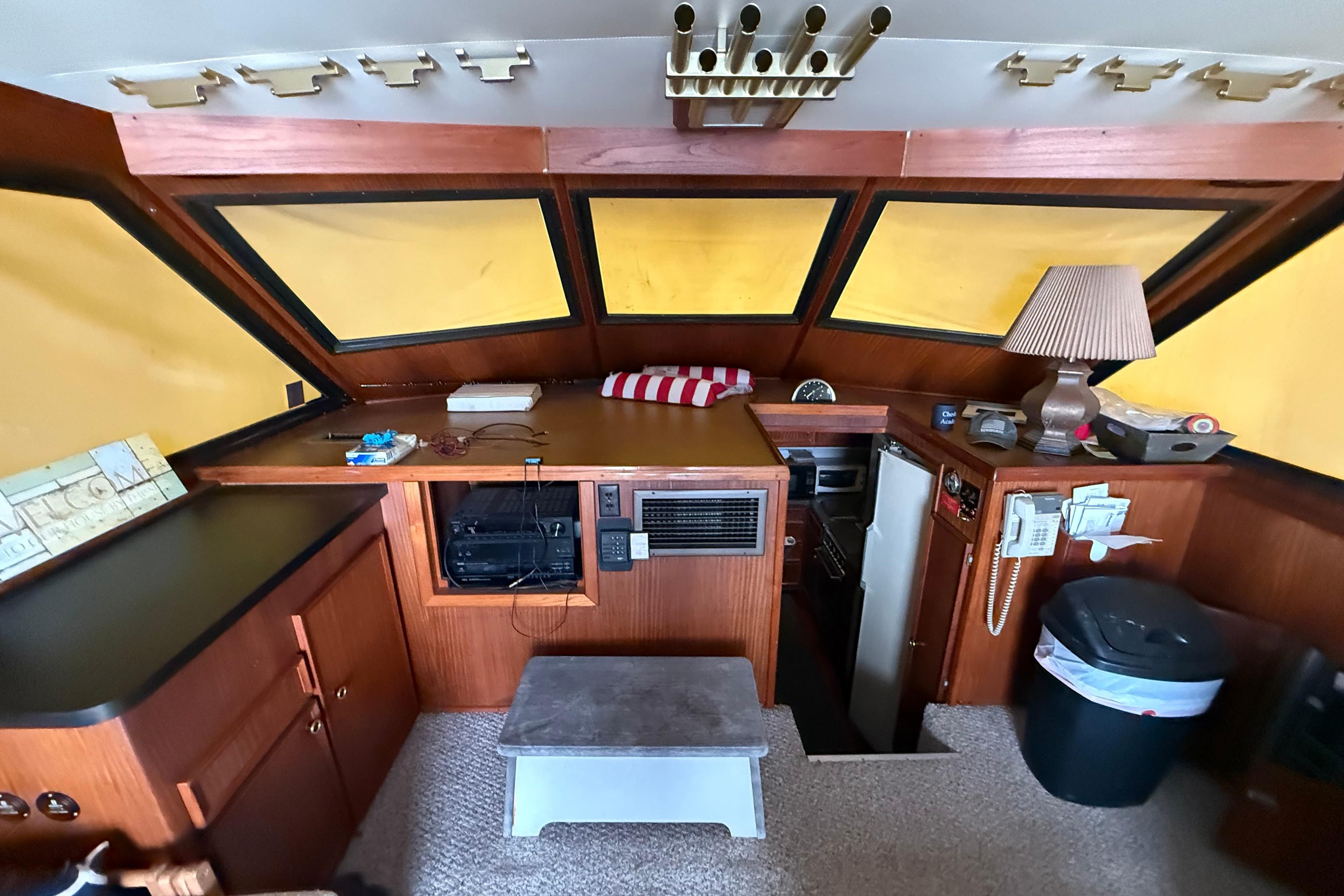 Interior of a 1979 Hatteras 46 Convertible yacht with wood paneling and nautical decor.