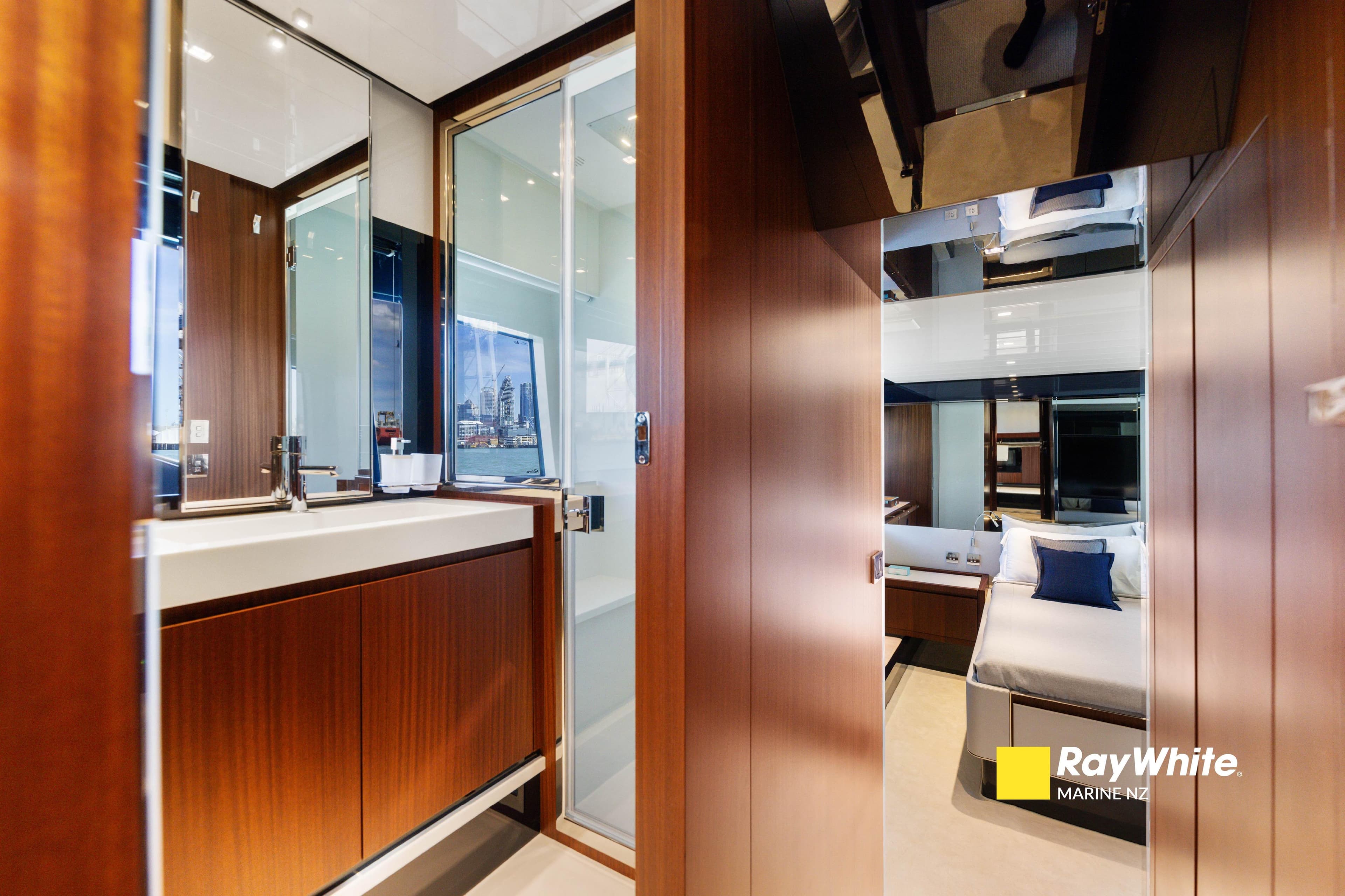 Luxurious interior of 2021 Riva 66' Ribelle yacht, featuring modern bathroom and cozy bedroom.