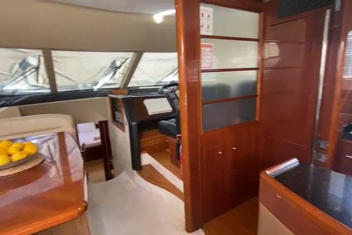 Luxurious interior of 2007 Princess 21M yacht with polished wood and modern design.