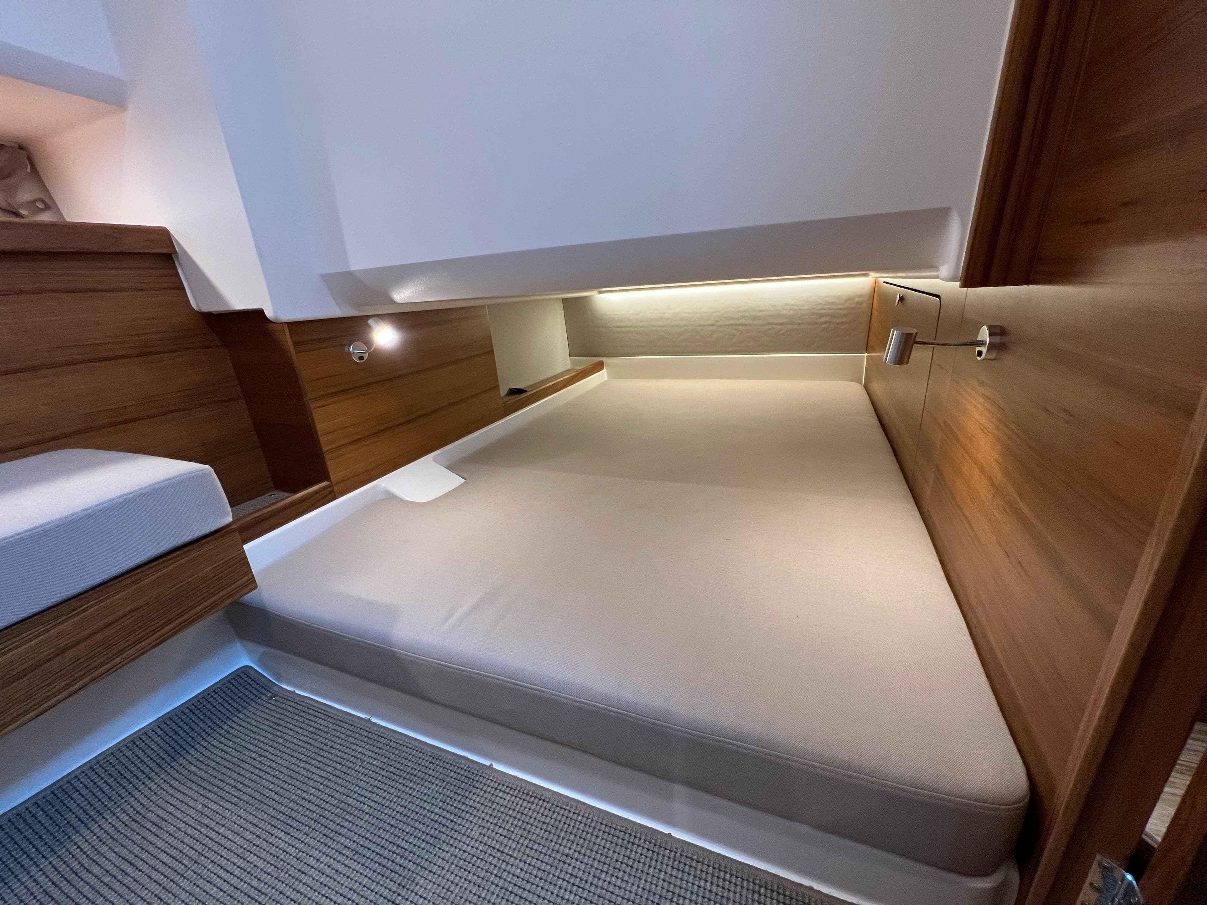 2021 Nimbus Tender 11 cabin interior with wooden accents and cozy bedding.
