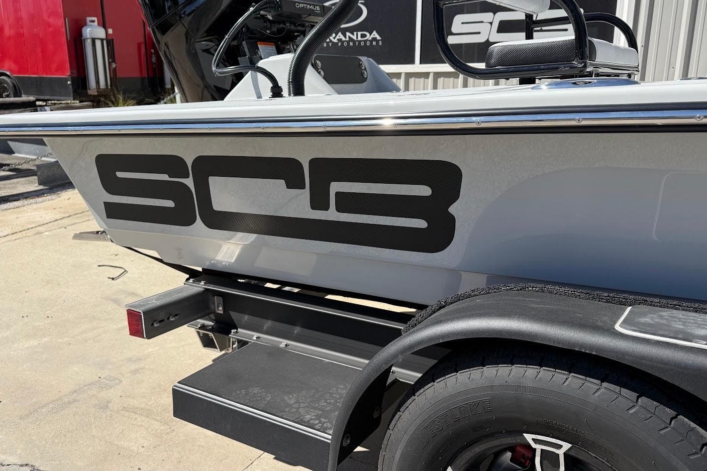 2026 SCB R24 boat on trailer, featuring bold SCB logo on the side.