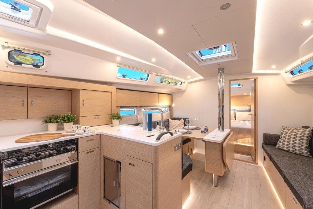 Interior of 2026 Hanse 360 yacht with modern kitchen and dining area.