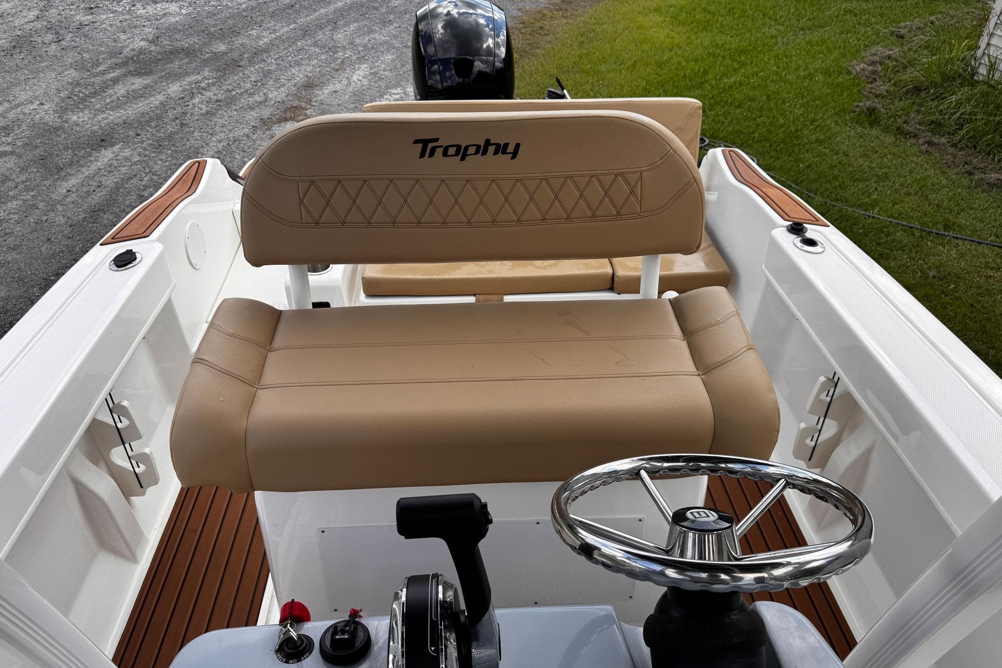 2023 Bayliner Trophy T20CC boat interior with tan seating and steering wheel.