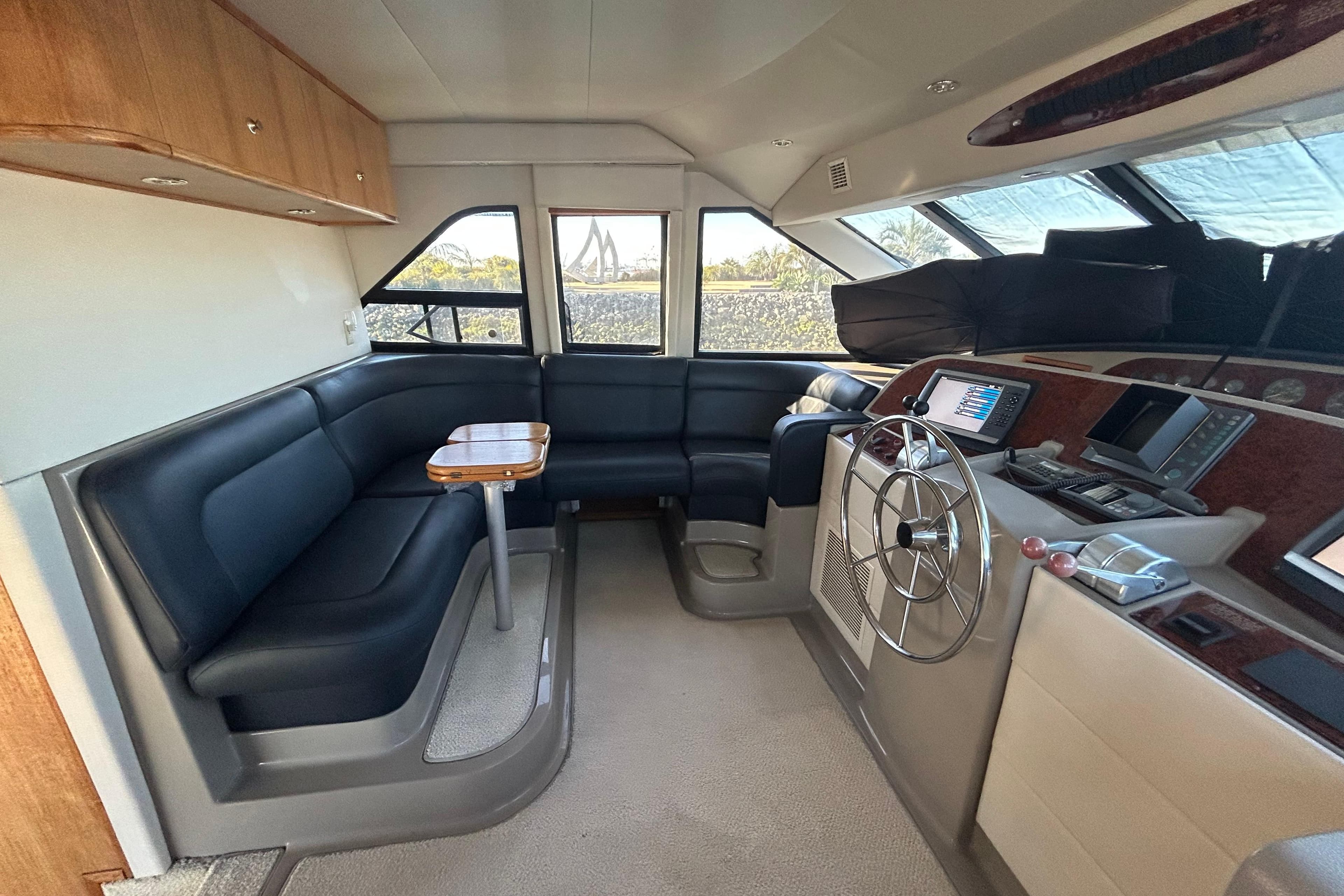 1998 Bayliner 5788 Pilot House Motoryacht interior with helm, seating, and navigation equipment.