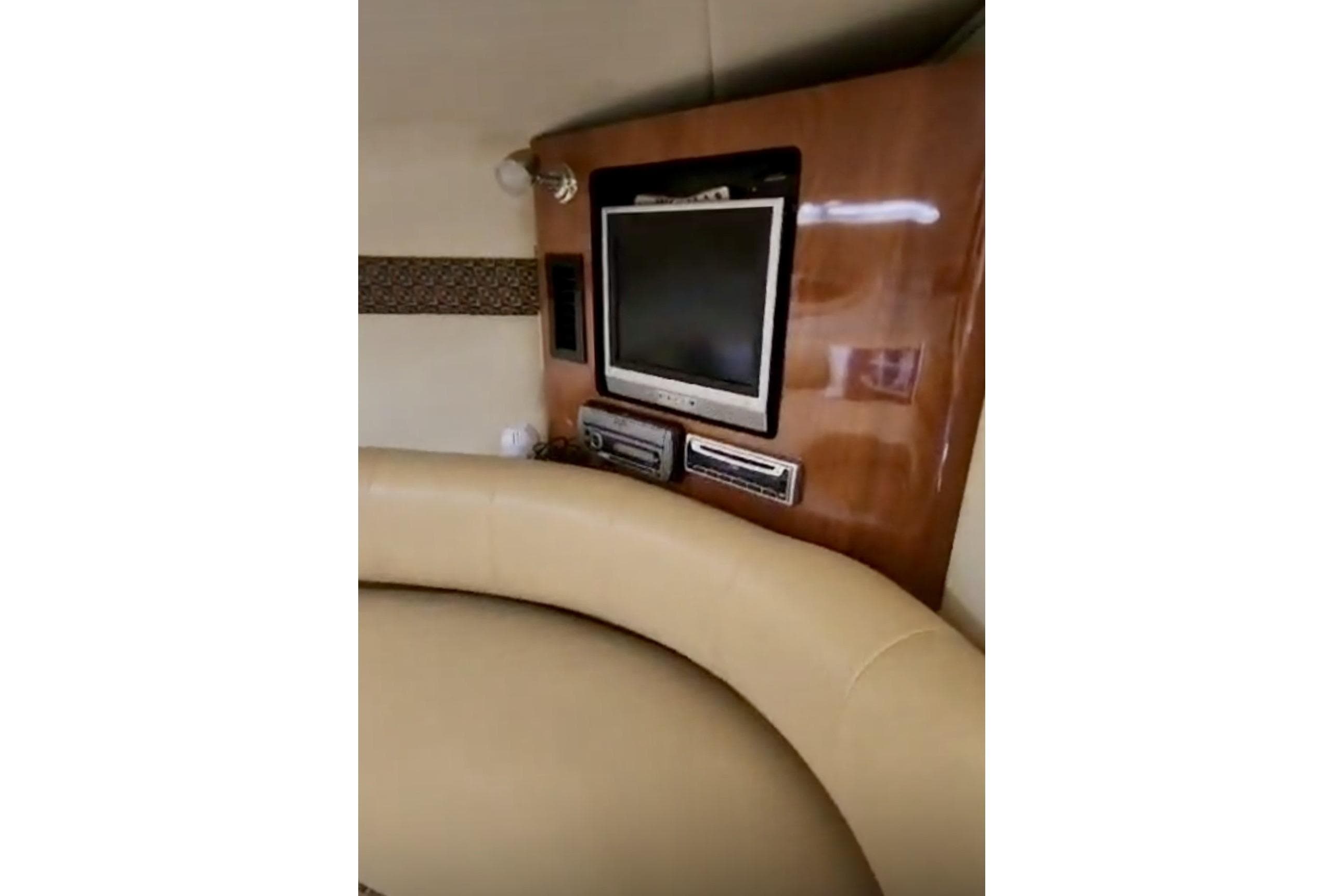 Interior of 2006 Monterey 298SC Super Sport with TV and beige seating.