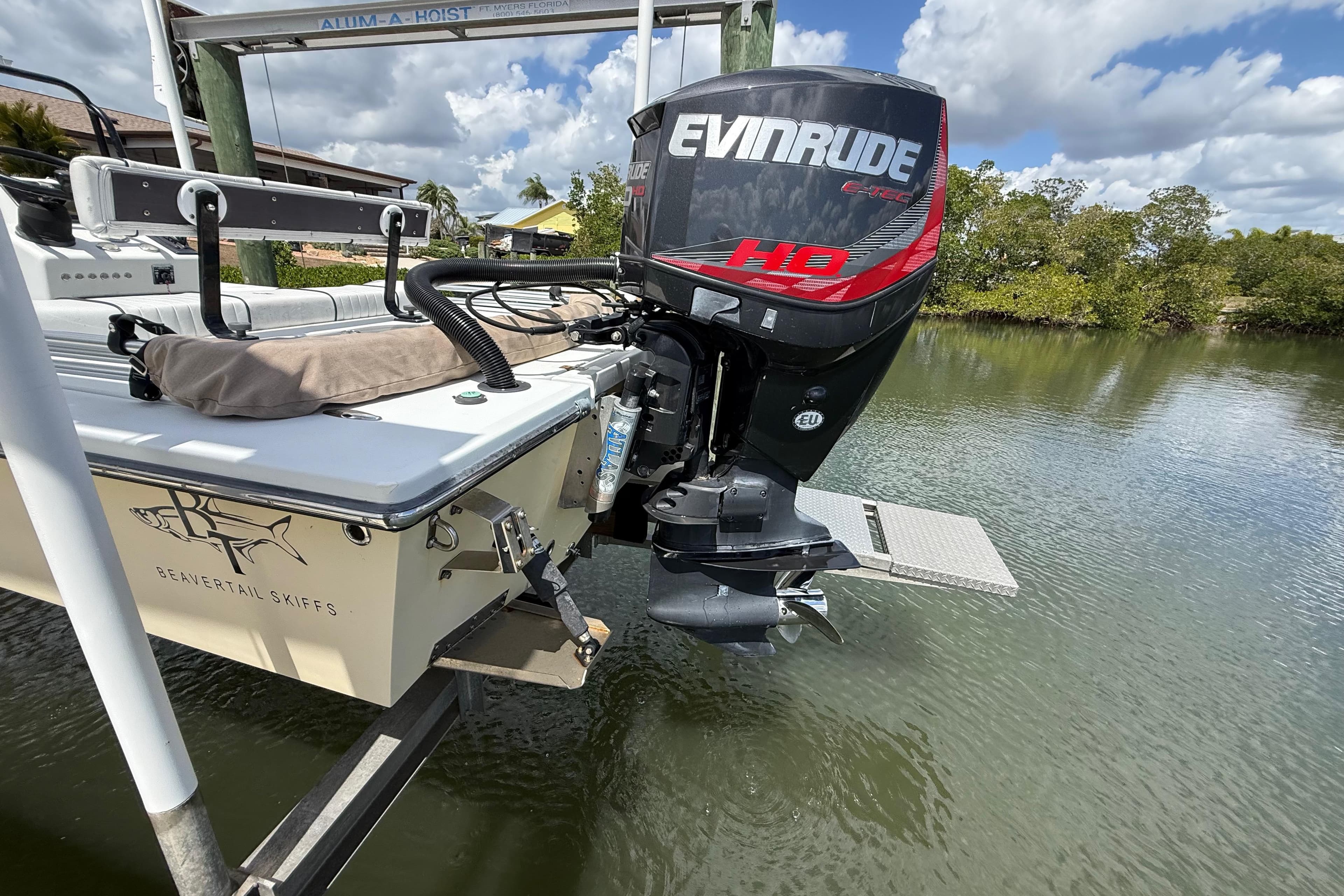2017 Beavertail Skiffs Lightning with Evinrude motor on a lift over water.