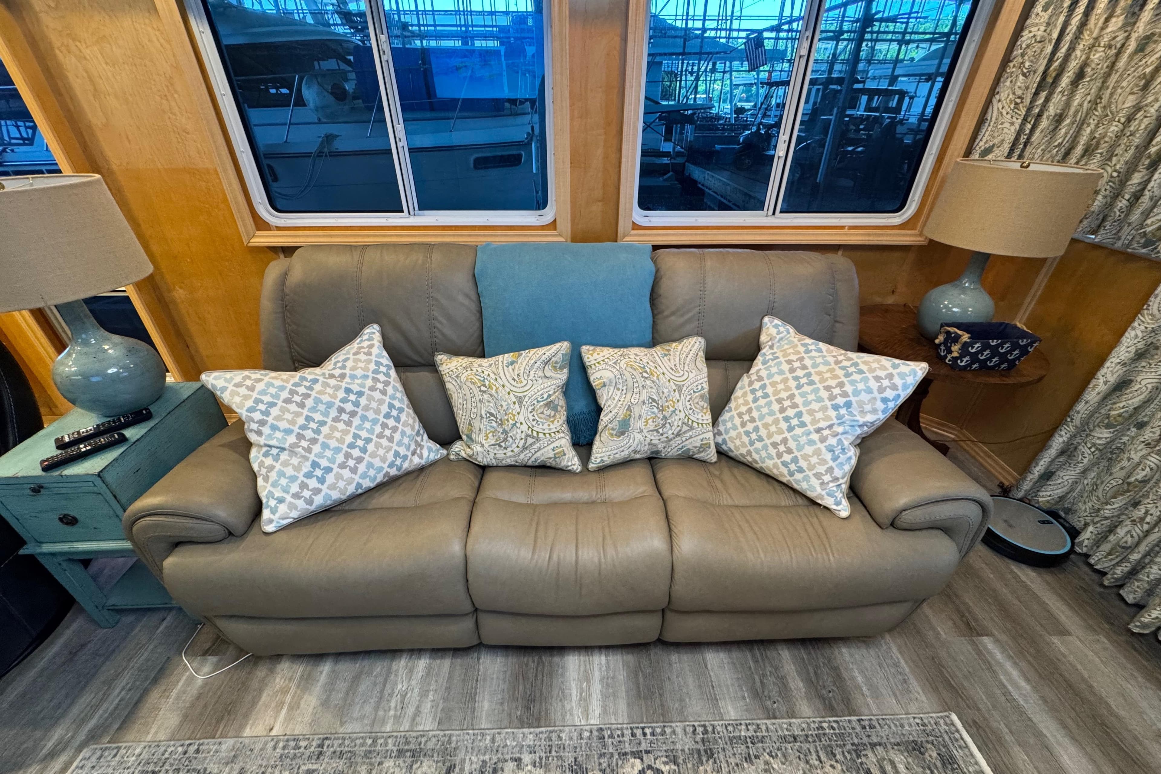Luxurious leather sofa with patterned pillows in a cozy Starlite 65x16 houseboat interior.