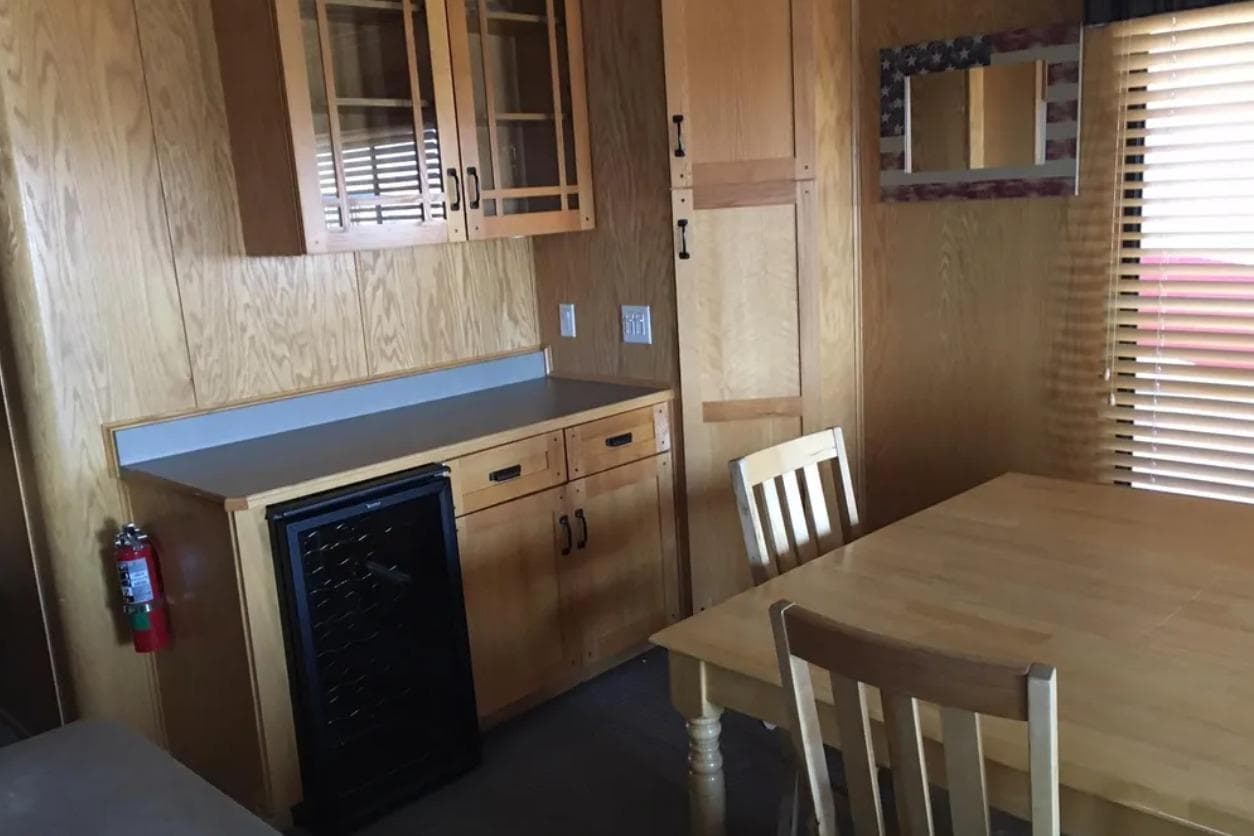 Wooden interior of 2005 Sumerset Star Chaser, featuring dining area and cabinetry.