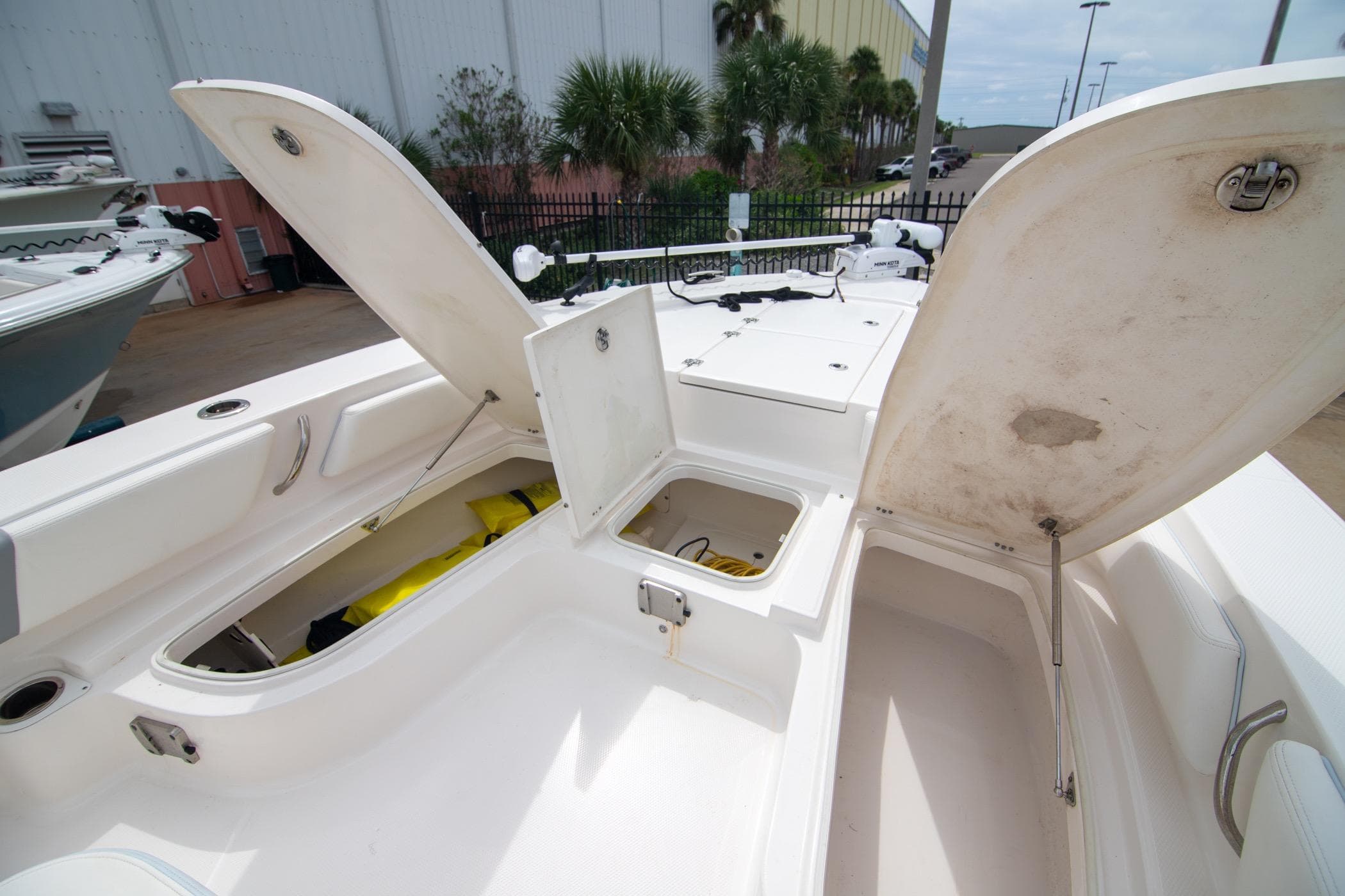 2023 Robalo 246 Cayman boat storage compartments open, showcasing spacious interior design.