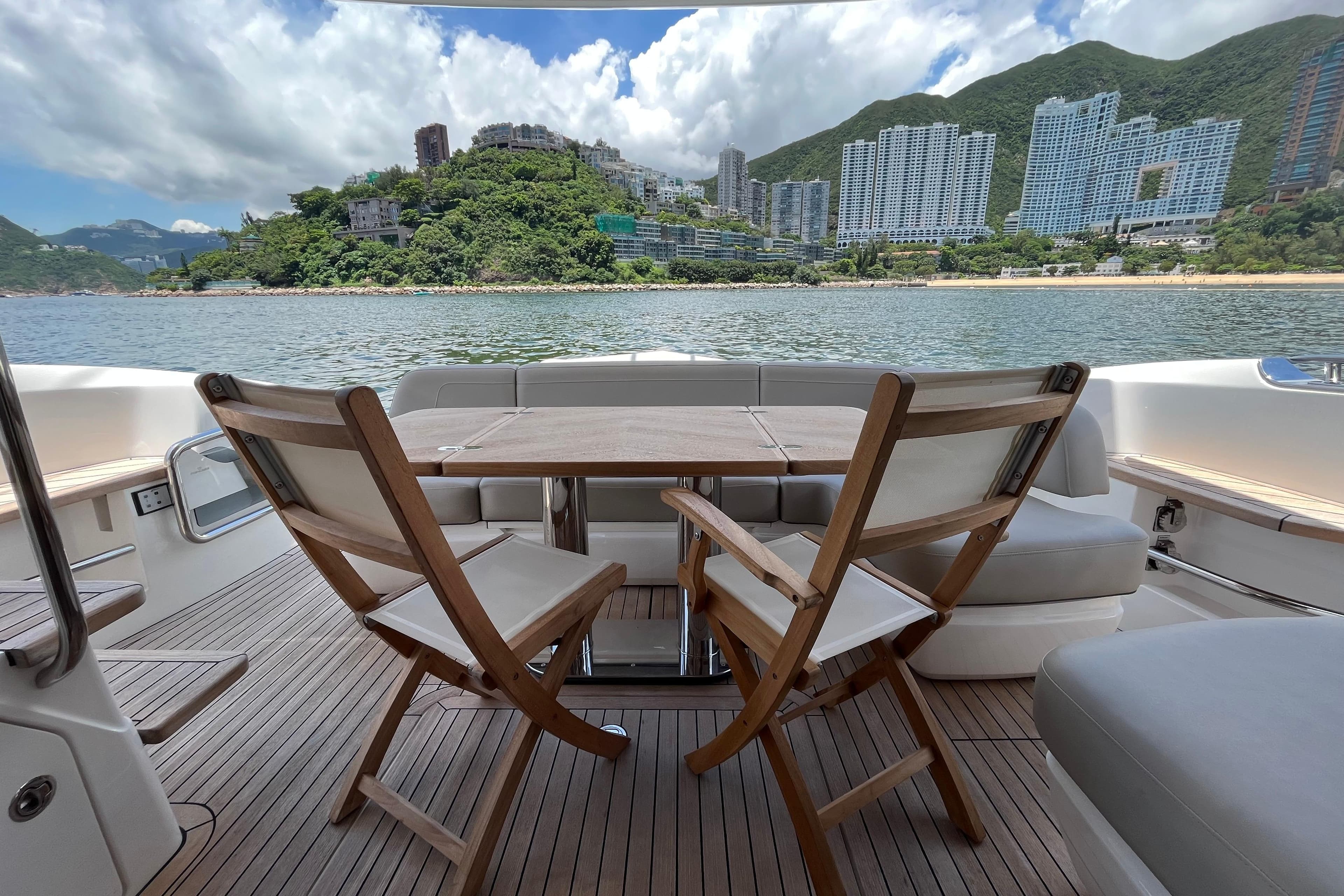 Luxurious 2020 Princess 45 Flybridge Motor Yacht with scenic waterfront view.