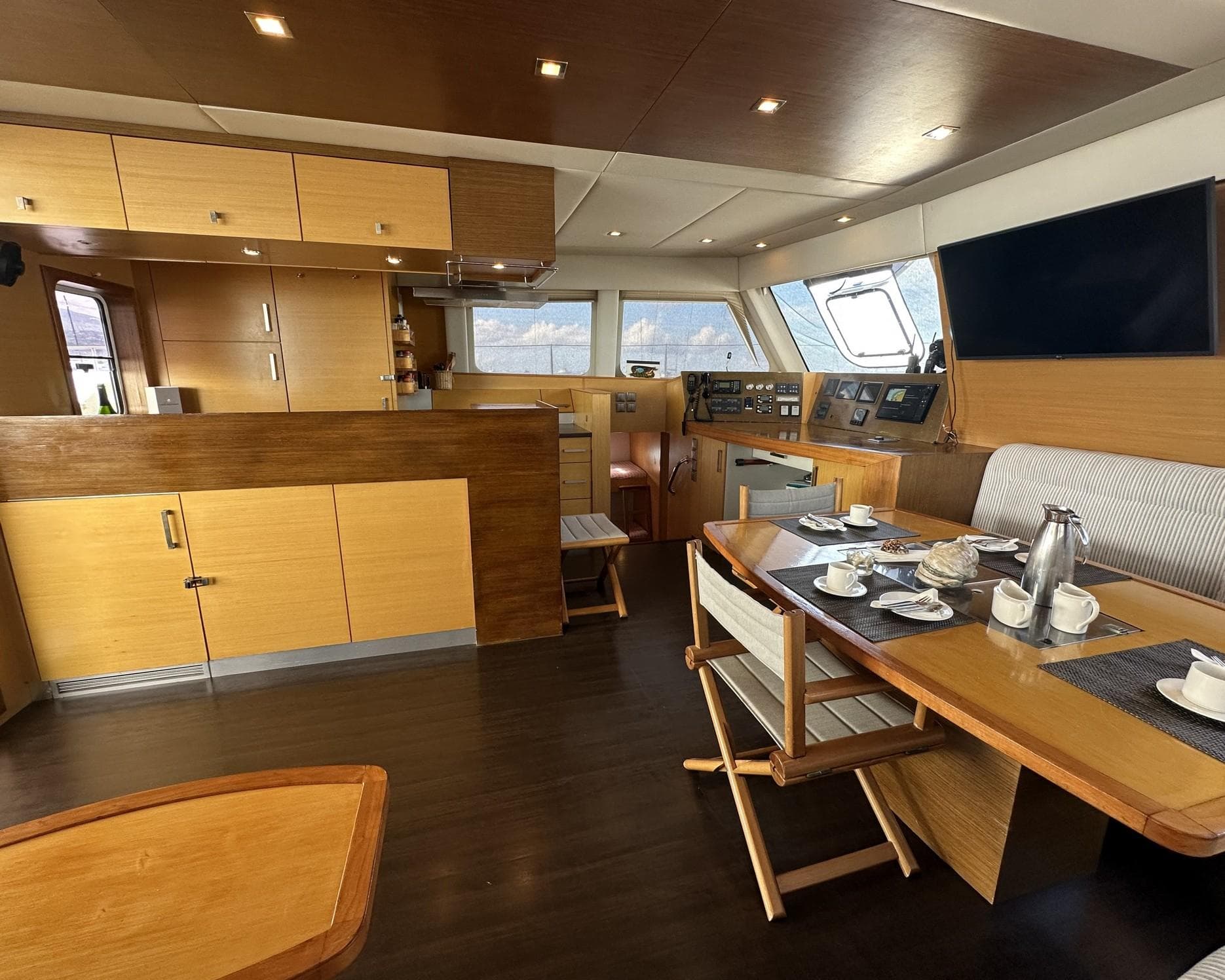 Luxurious interior of 2008 Sunreef 62 yacht with modern kitchen and dining area.