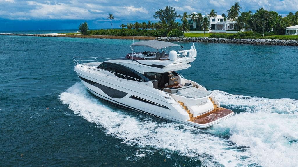 Luxurious 2022 Princess S66 yacht cruising in scenic coastal waters.