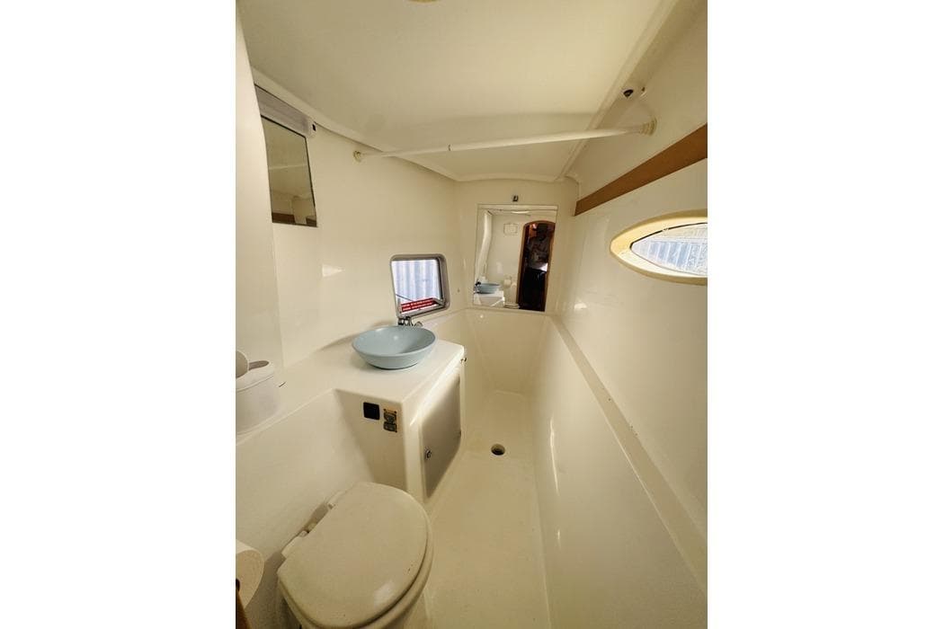2010 Fountaine Pajot Mahe yacht bathroom with modern fixtures and porthole window.