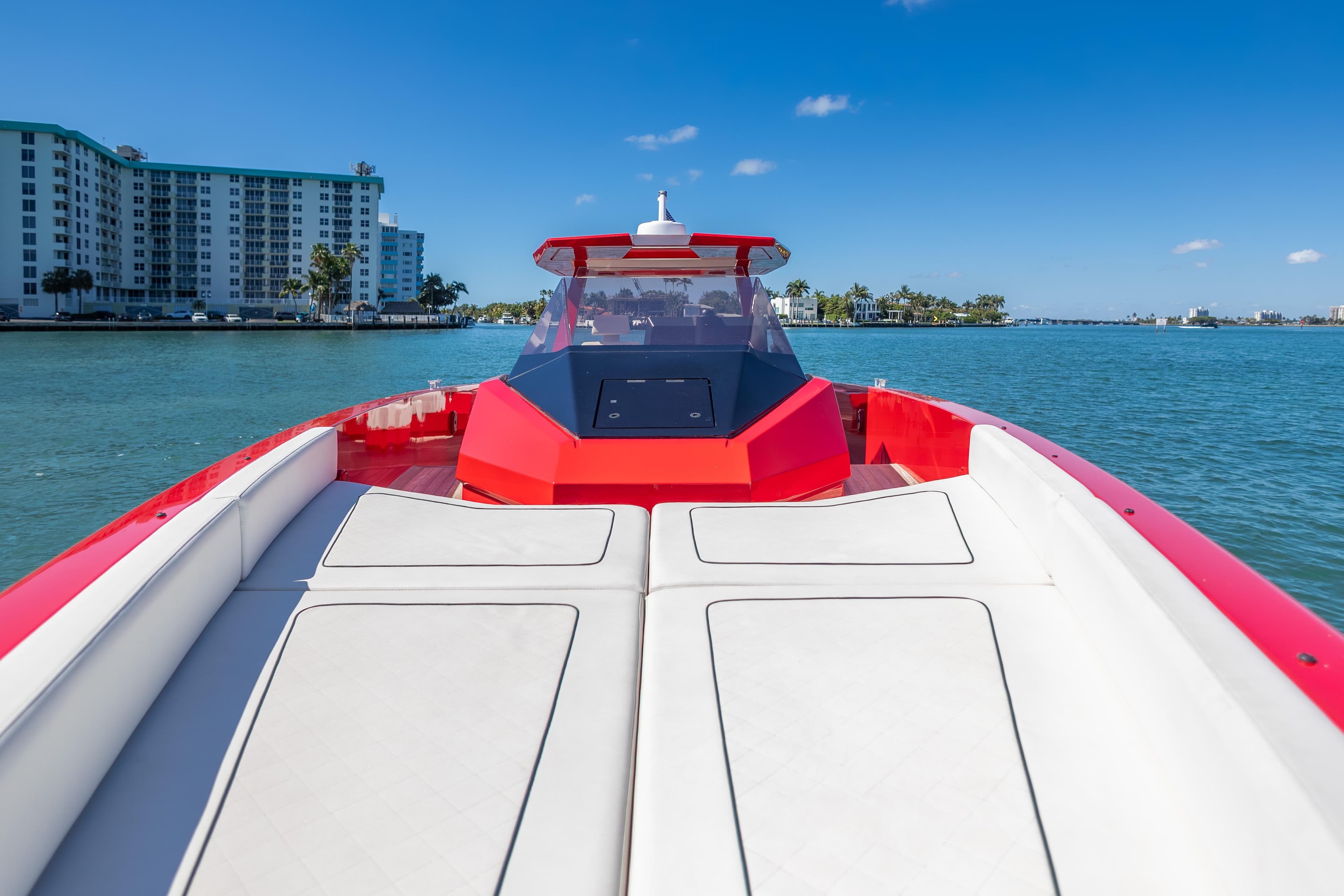 2021 Wally 48 boat cruising on a sunny day near waterfront buildings.