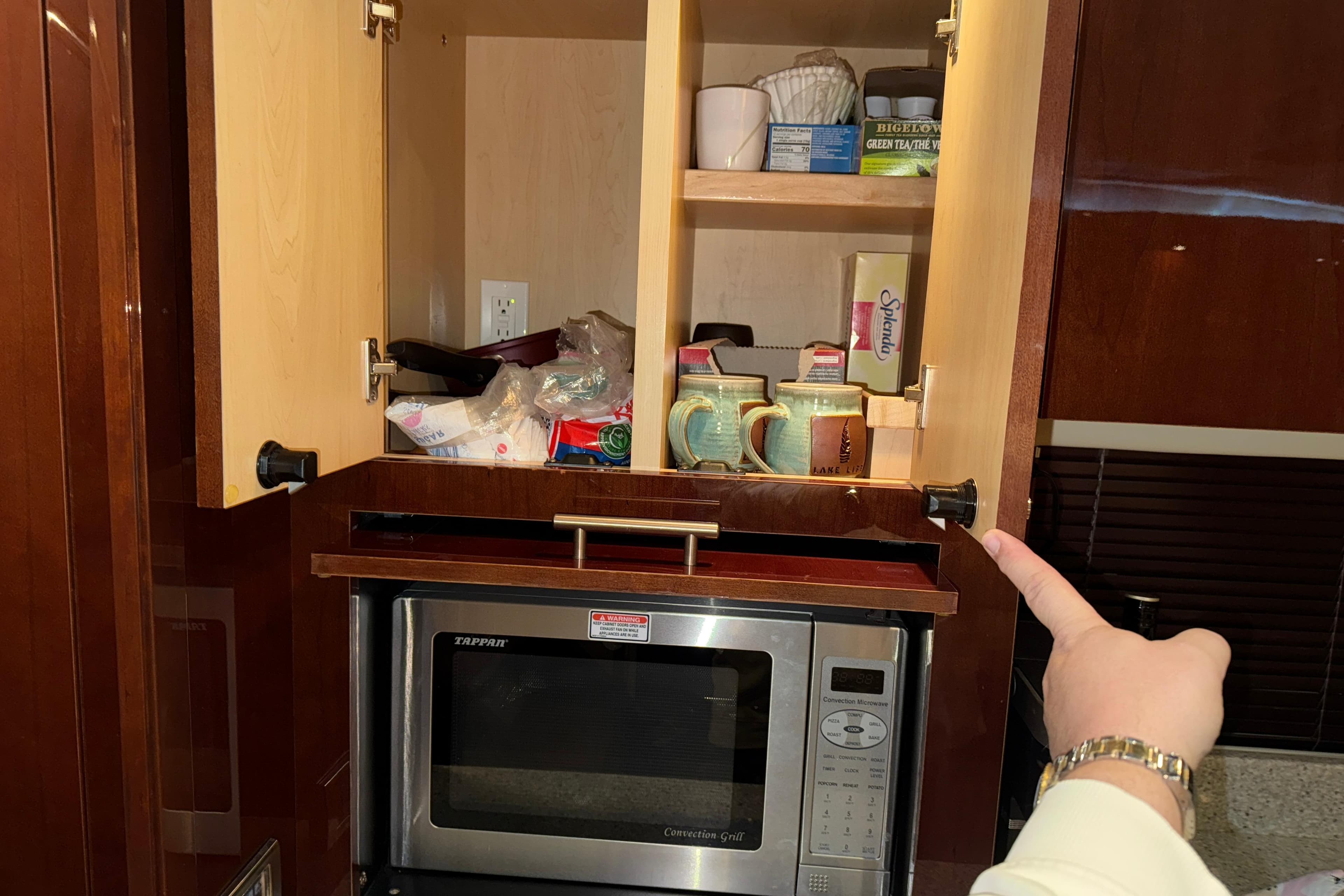 Cabinet and microwave in 2008 Sea Ray 55 Sundancer yacht kitchen.