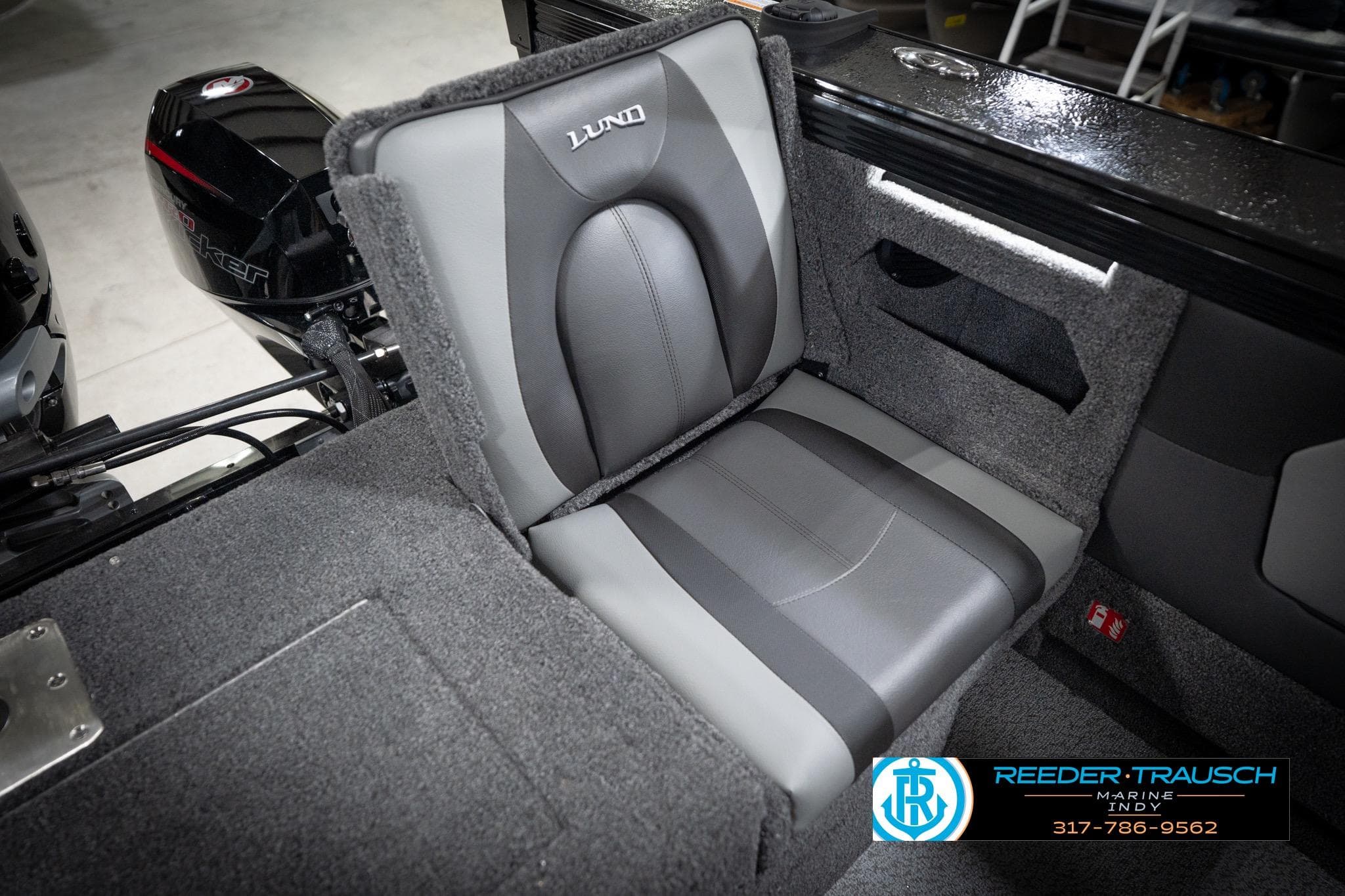2026 Lund 2275 Baron boat interior with gray seating and motor detail.
