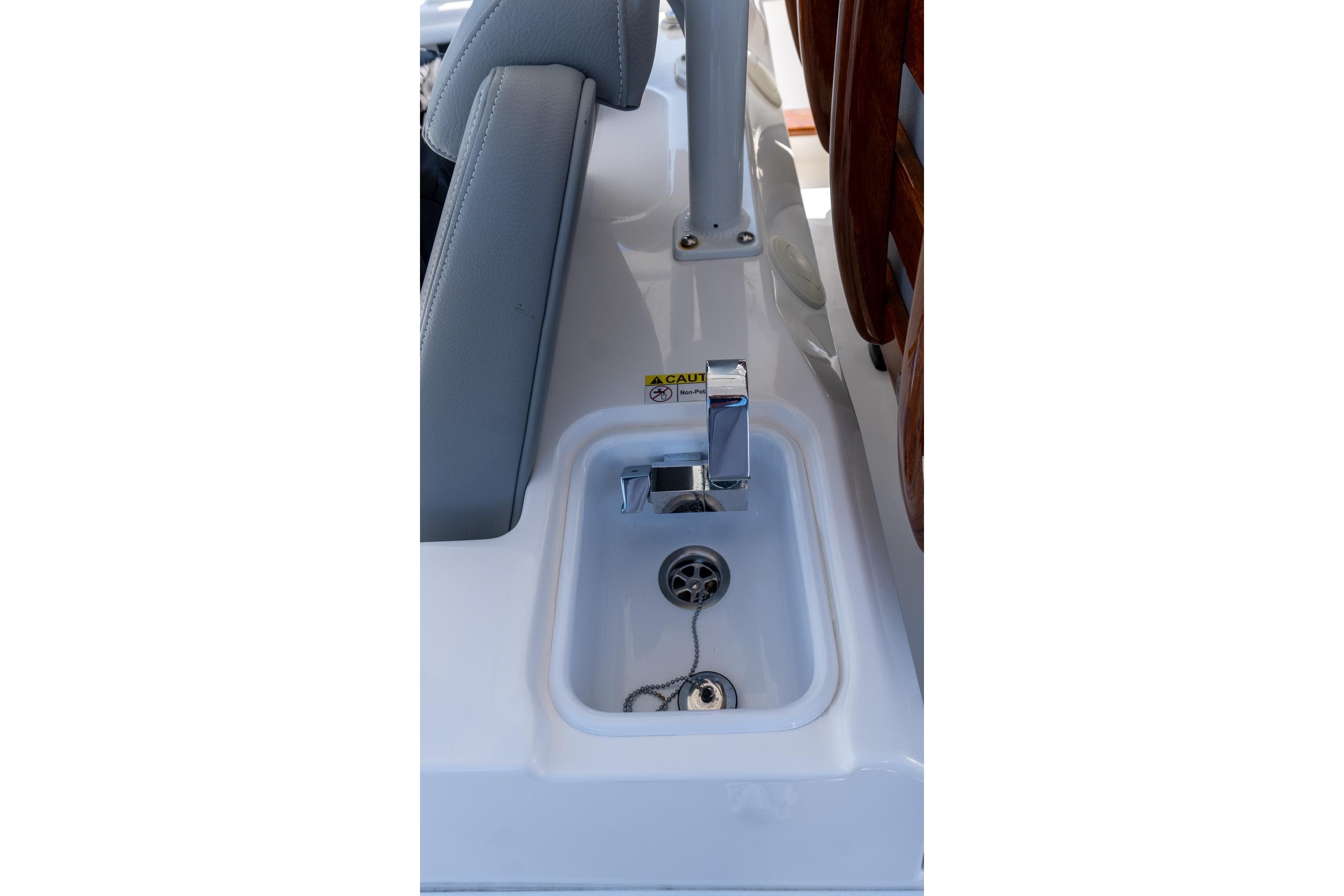 2024 Everglades 395 Center Console boat sink with chrome faucet and drain plug.