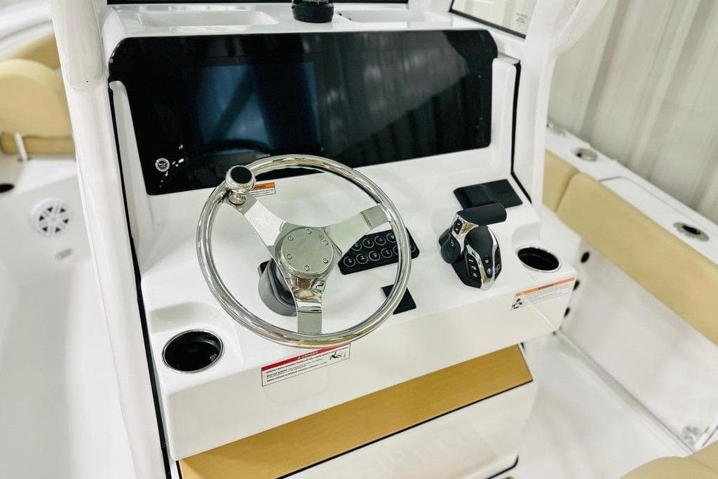2026 Sportsman Open 232 Center Console boat dashboard with steering wheel and controls.