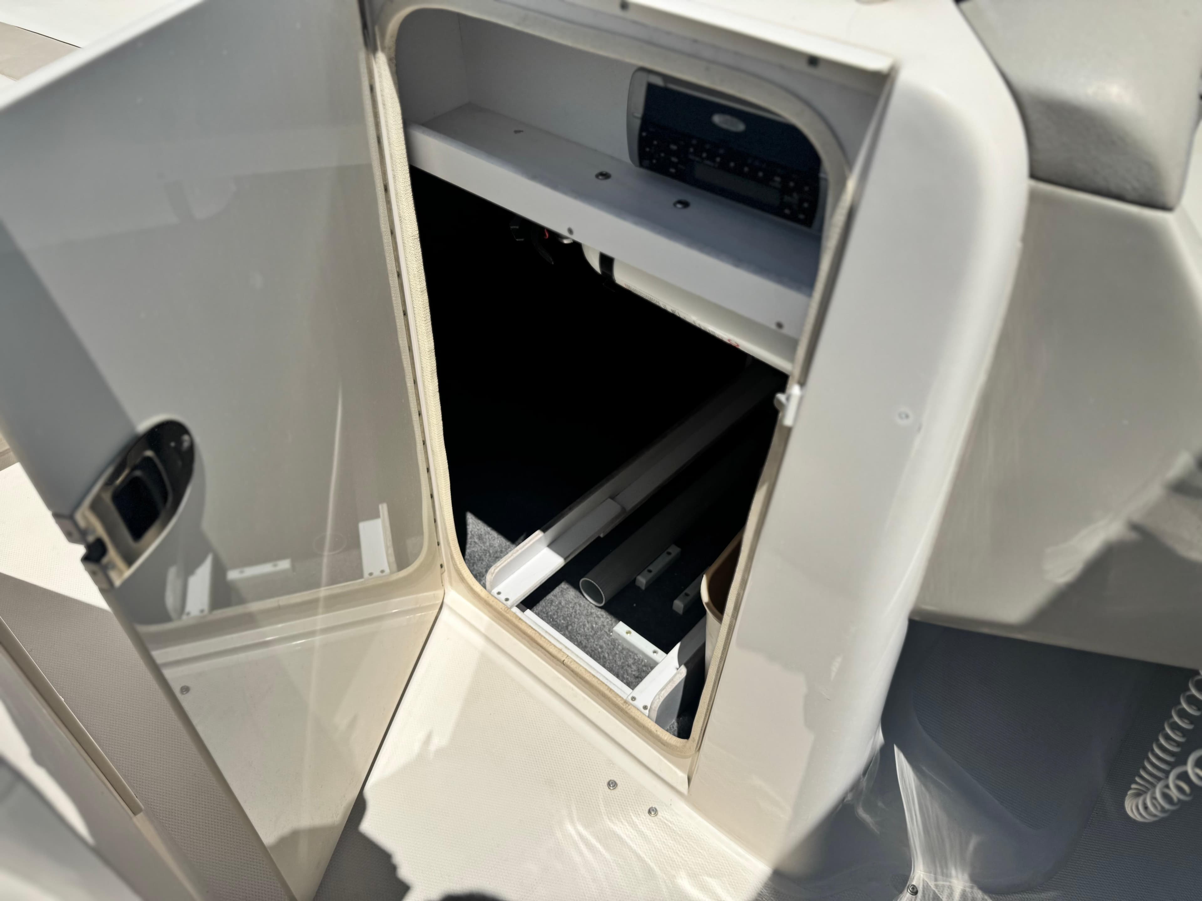 Open storage compartment on a 2005 Sea Ray 240 Sundeck boat.