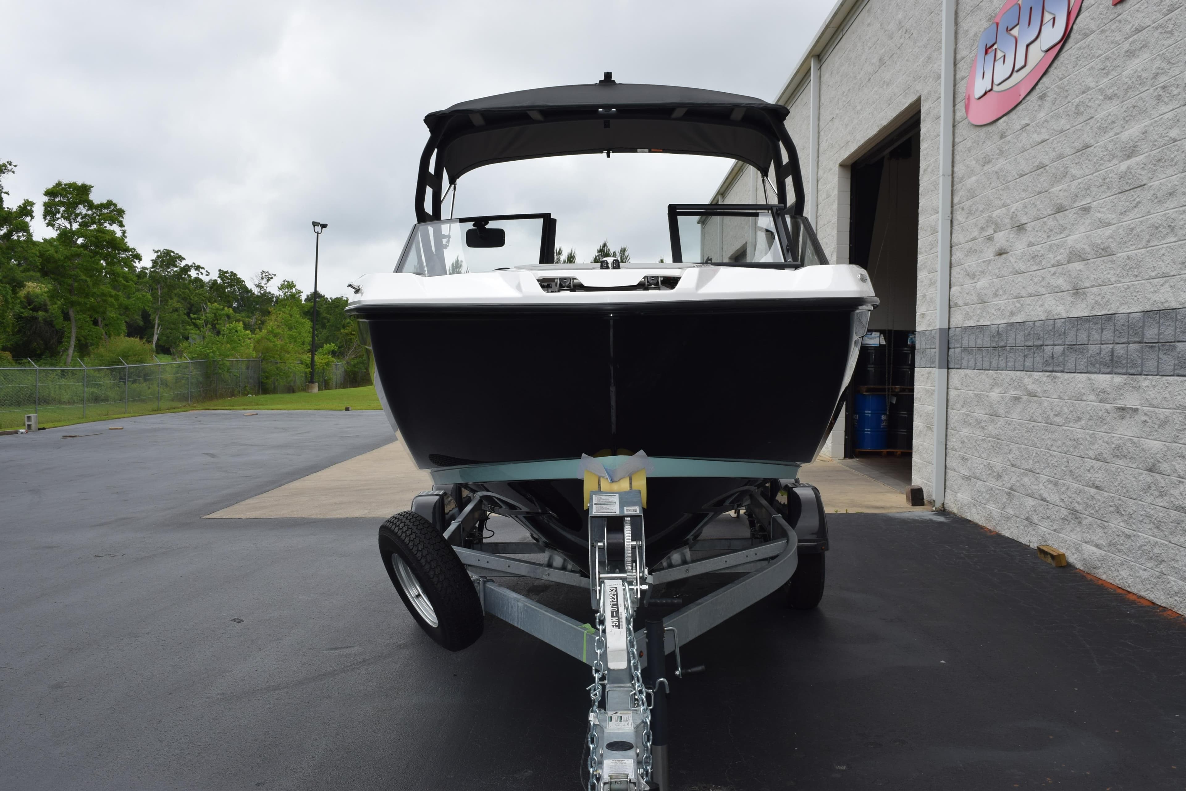 2026 Yamaha Boats AR220 on trailer outside a building, ready for transport.