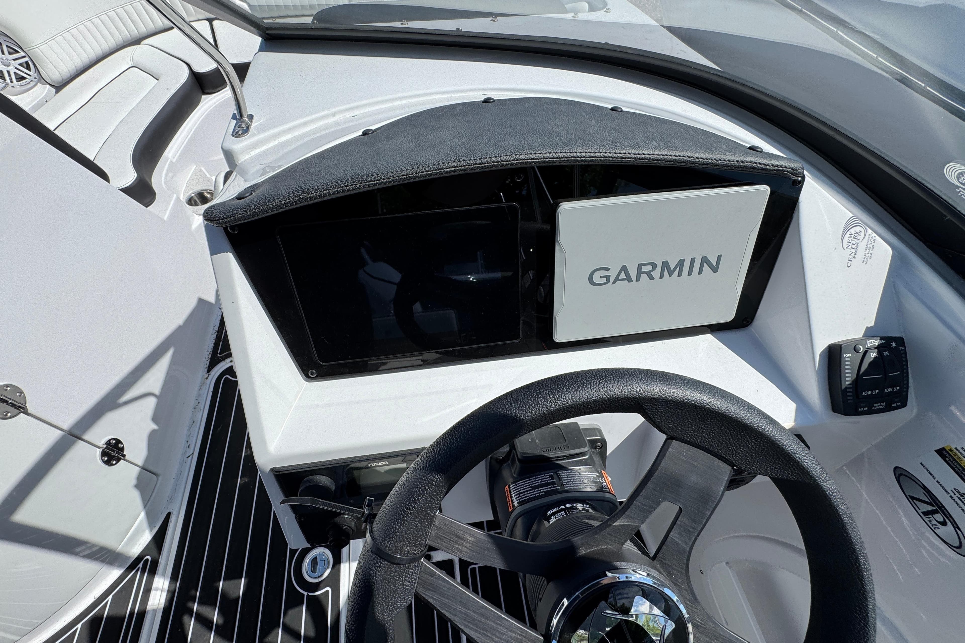 2026 Stingray 231 DC boat dashboard with Garmin navigation system and steering wheel.