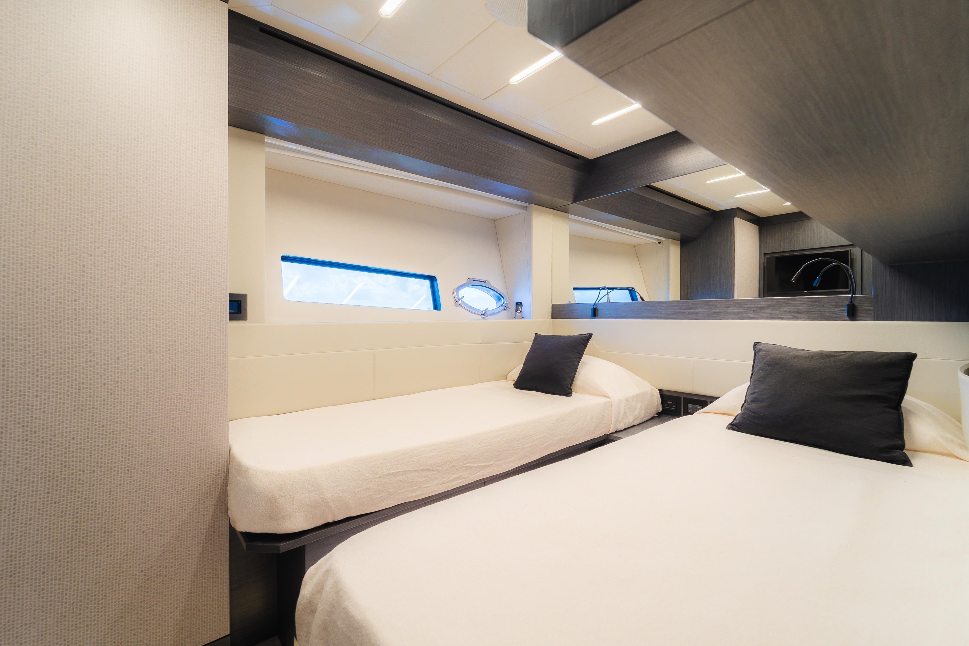 Luxurious twin bedroom interior on 2021 Pershing 8X yacht, featuring modern design.
