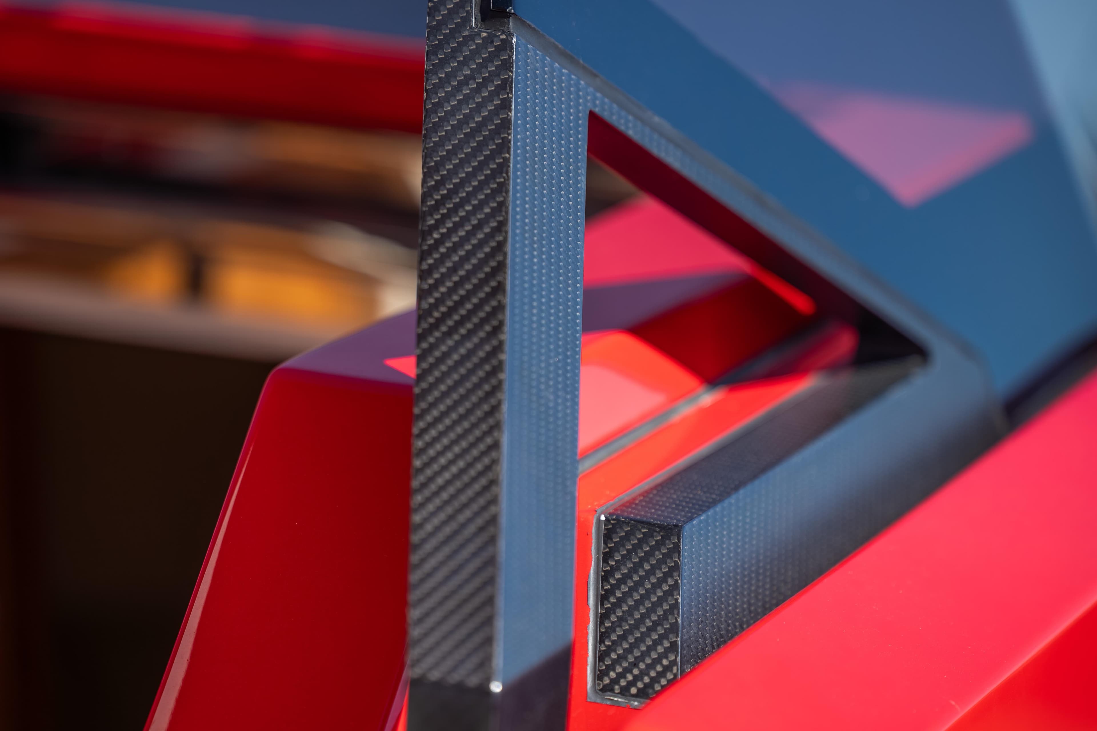 Close-up of 2021 Wally 48 yacht's sleek, modern carbon fiber and red design elements.