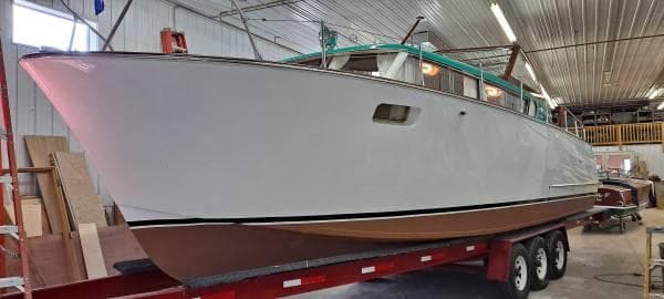 1961 Chris-Craft Roamer boat on trailer in indoor storage facility.