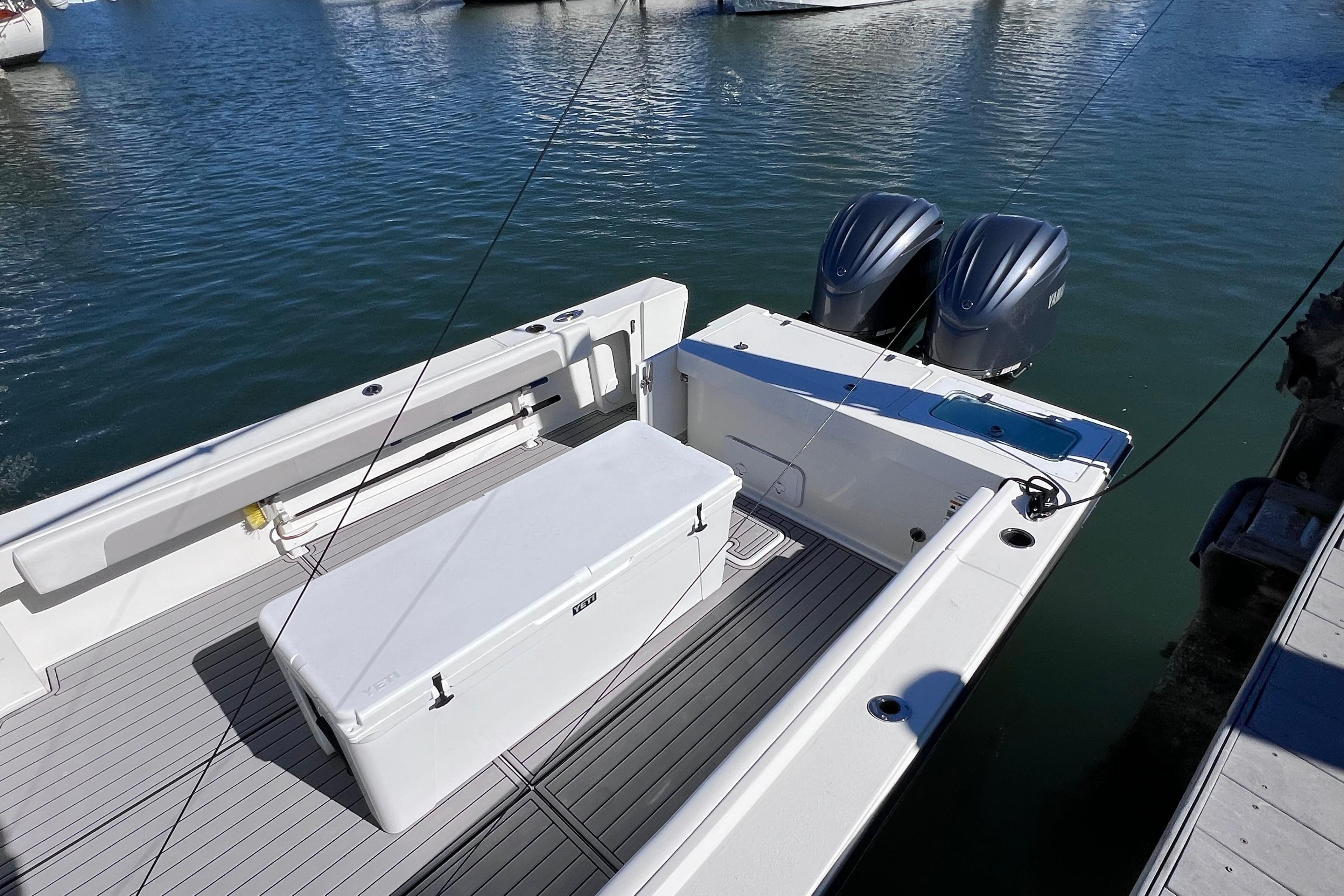 2023 Parker 2820 XLD Sport Cabin boat with dual engines, docked on calm water.
