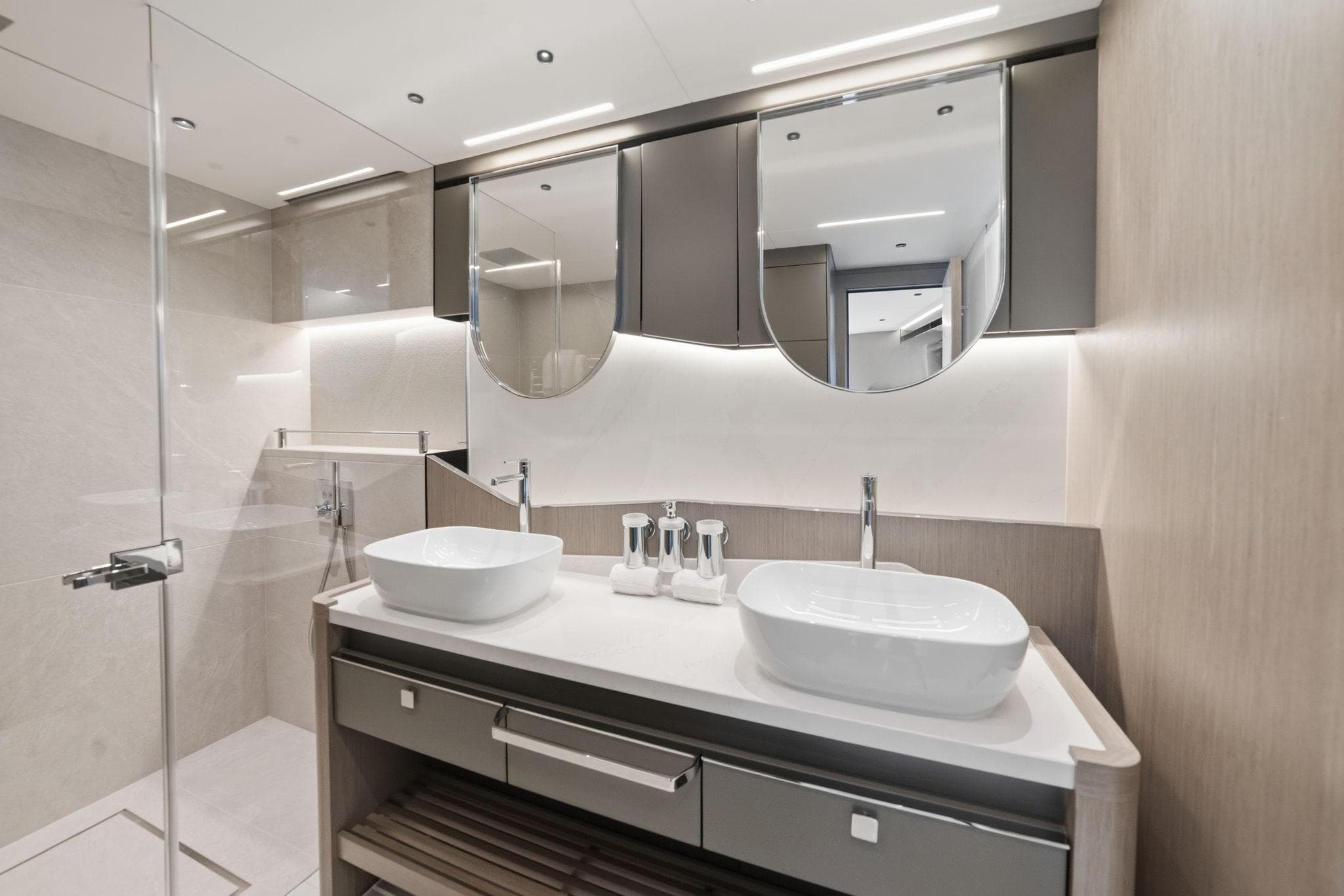 Luxurious bathroom in 2024 Sunseeker 100 Yacht with dual sinks and modern design.