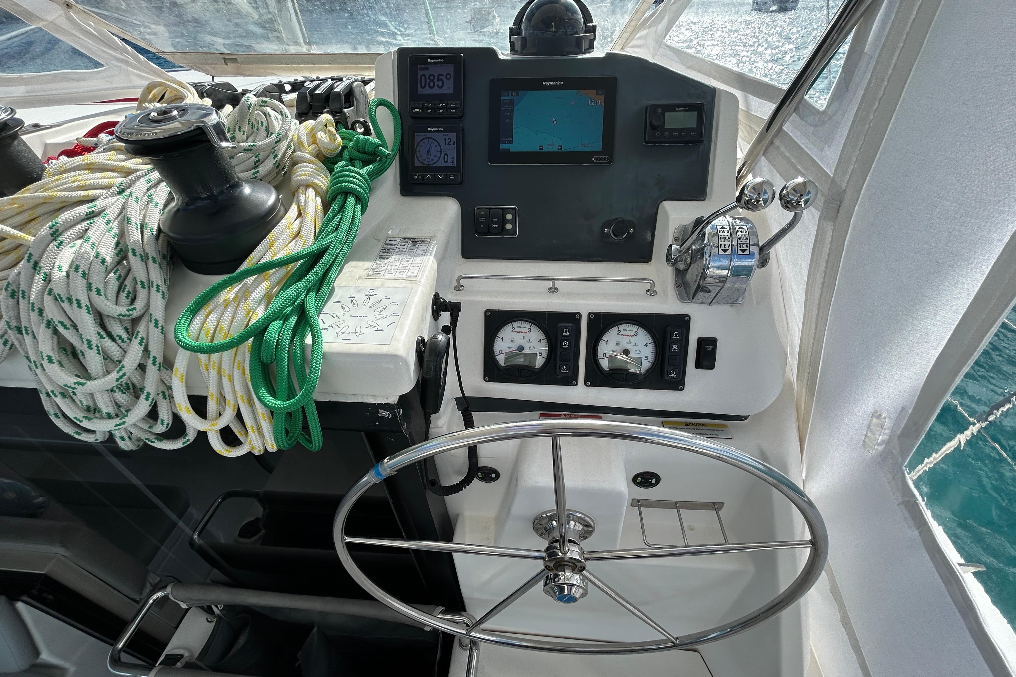 Cockpit of 2020 Leopard 45 yacht with steering wheel, ropes, and navigation instruments.