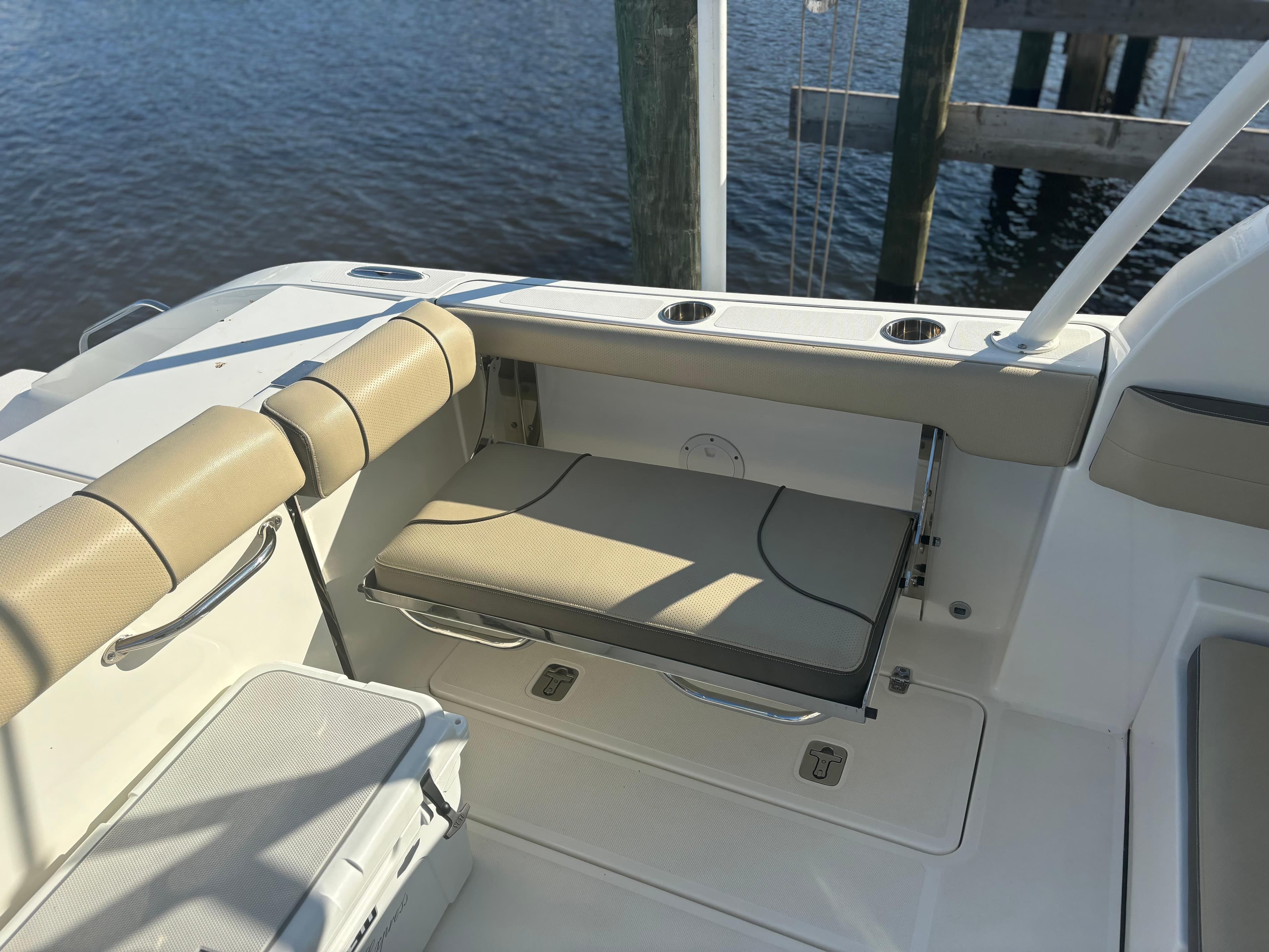 2020 Pursuit DC 295 Dual Console boat interior with beige seating and cup holders.