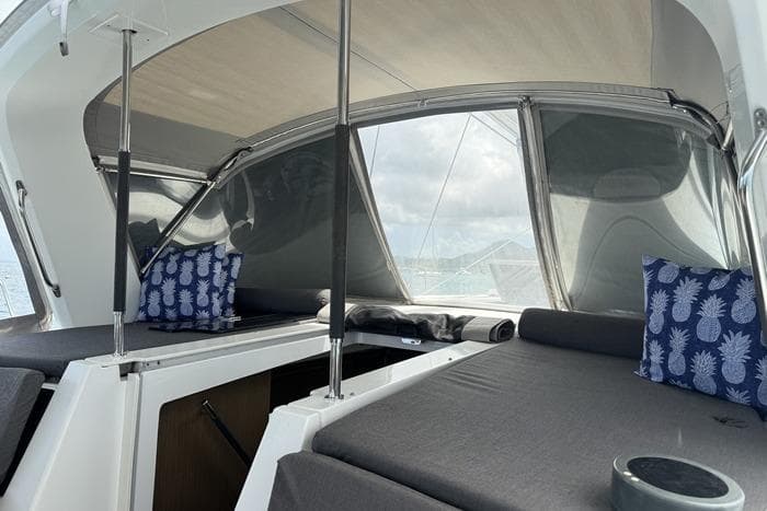 2020 Beneteau Oceanis 46.1 yacht cockpit with gray cushions and pineapple-patterned pillows.