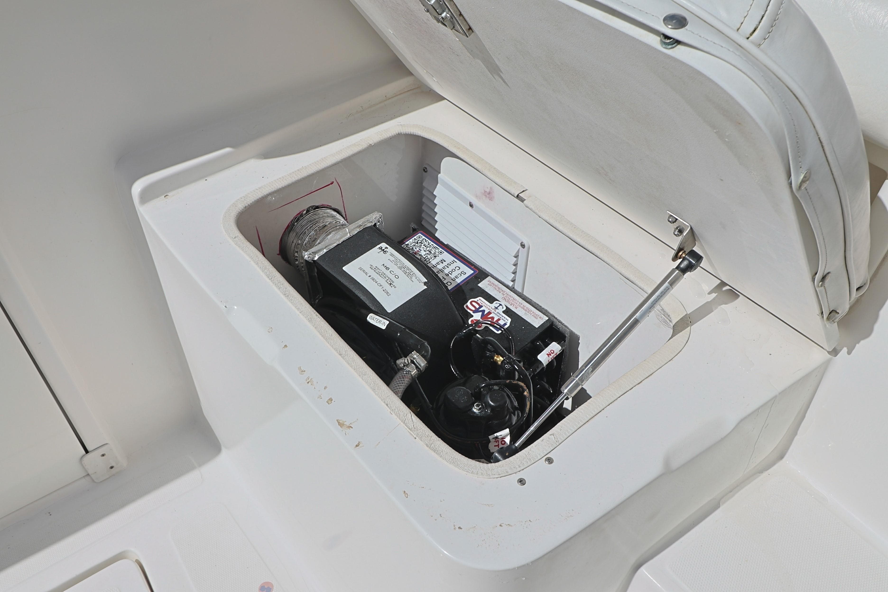 2004 Marlago 35 Sport Cuddy storage compartment with equipment inside.
