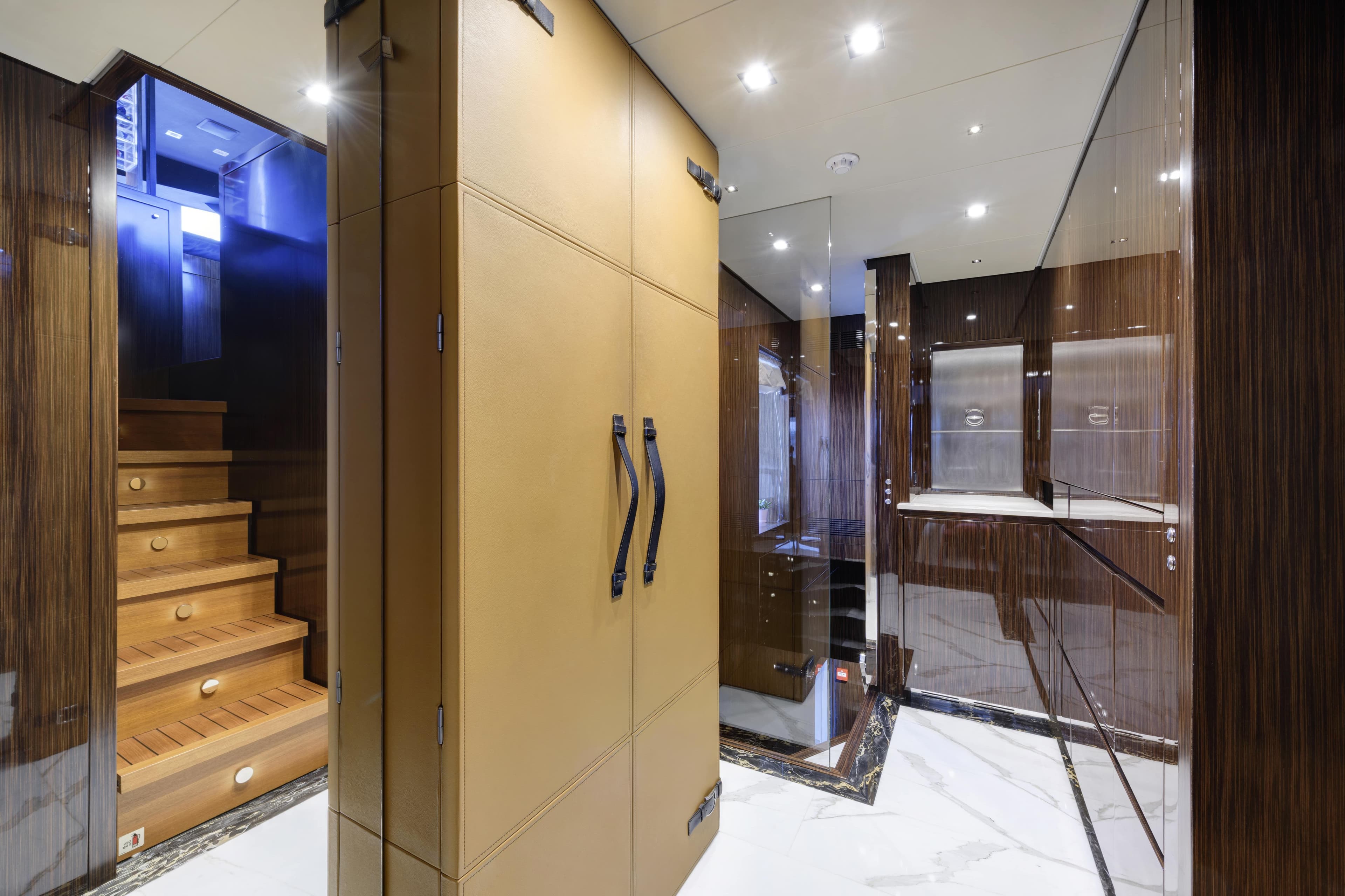 Luxurious interior of 2015 Mondomarine SF40 yacht with wooden stairs and modern design.