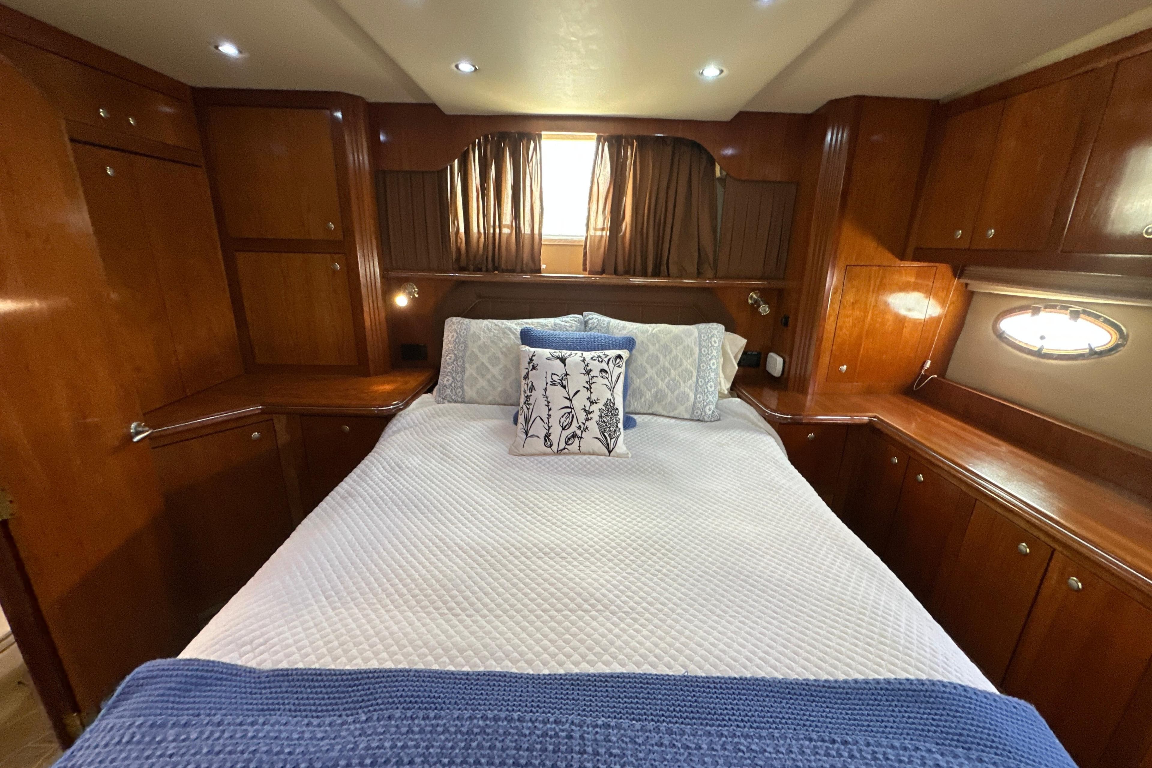 Luxurious cabin interior of 2004 Cruisers Yachts 405 Express Motoryacht with elegant wood finish.
