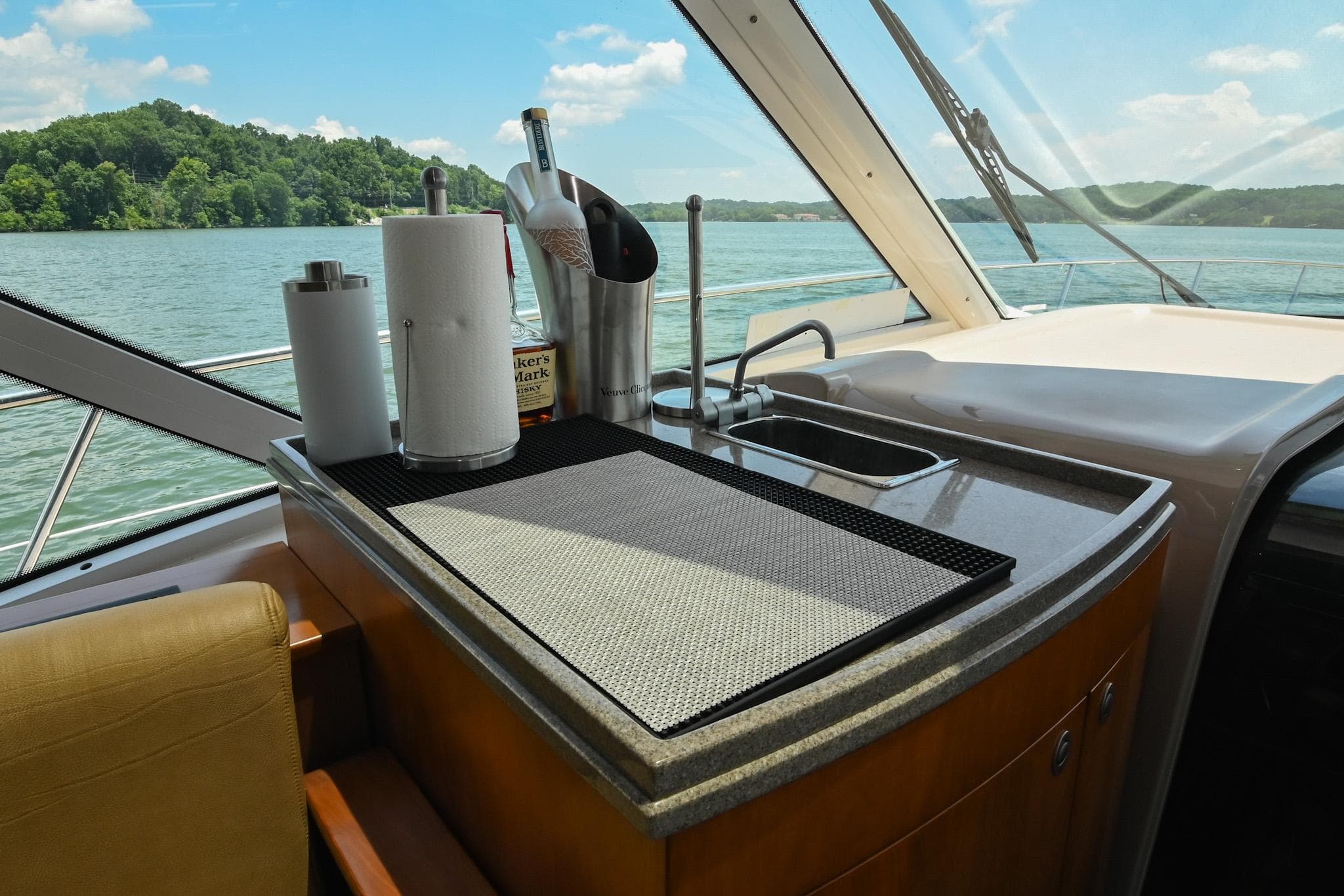 Luxurious 2007 Sea Ray 60 Sundancer yacht interior with kitchenette and scenic lake view.
