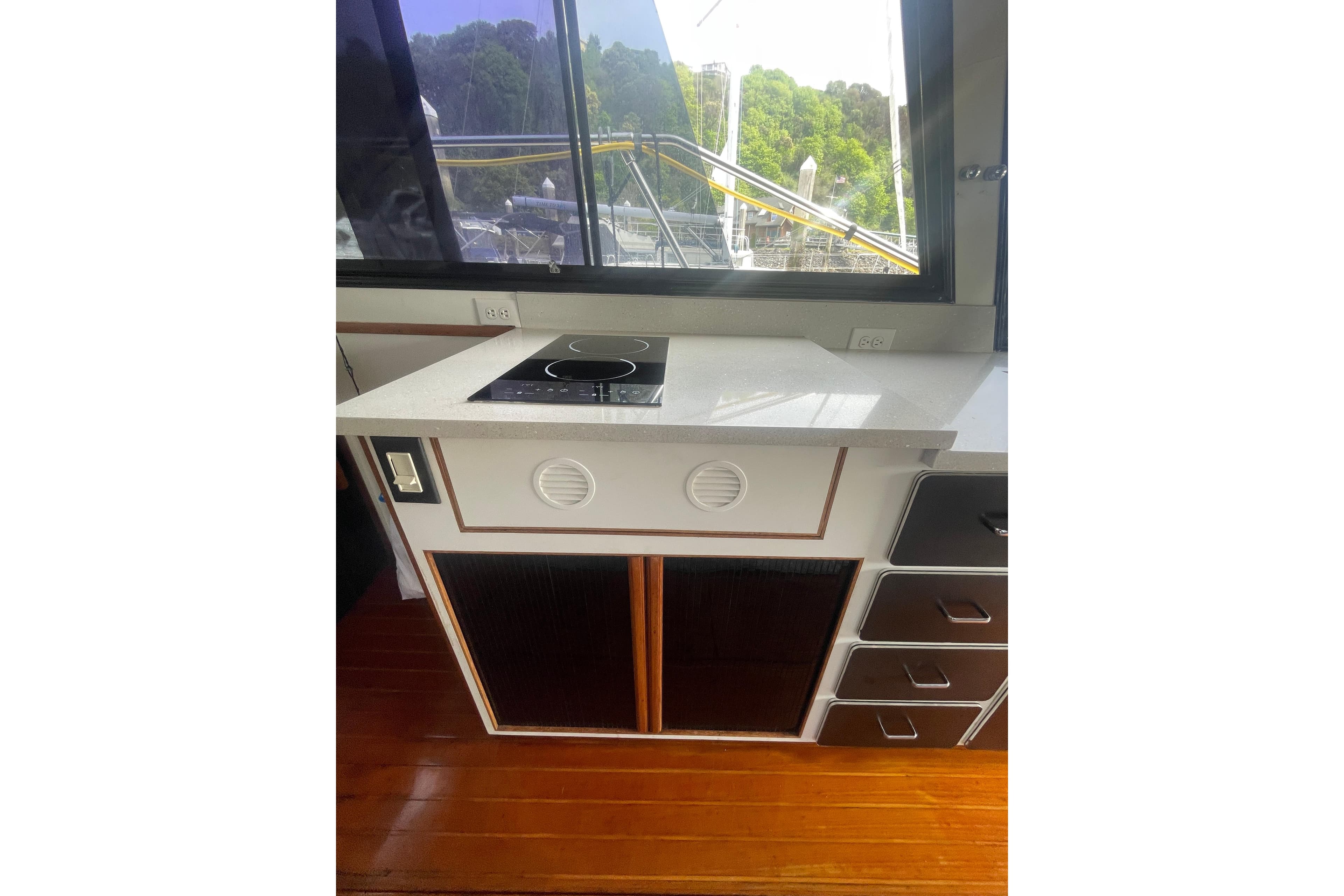 1986 Hi-Star 40 Flybridge yacht kitchen with stove, countertop, and window view.