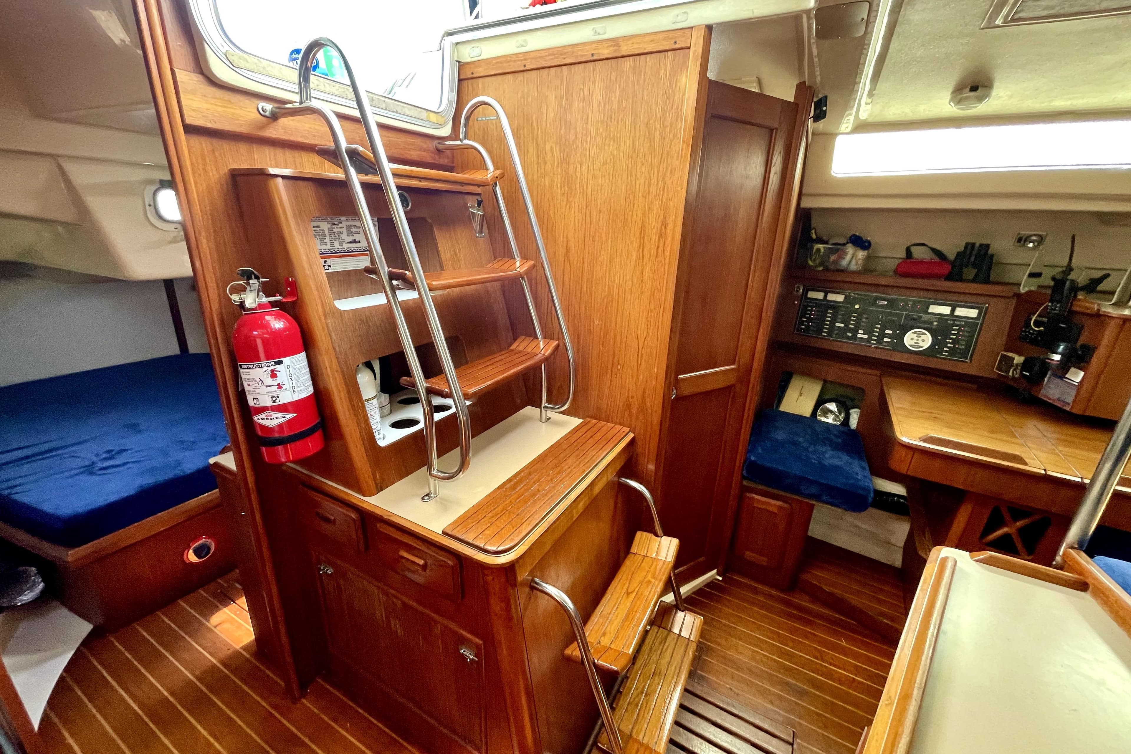 Interior of 1989 Hunter 40 Legend sailboat with wooden finish and navigation station.
