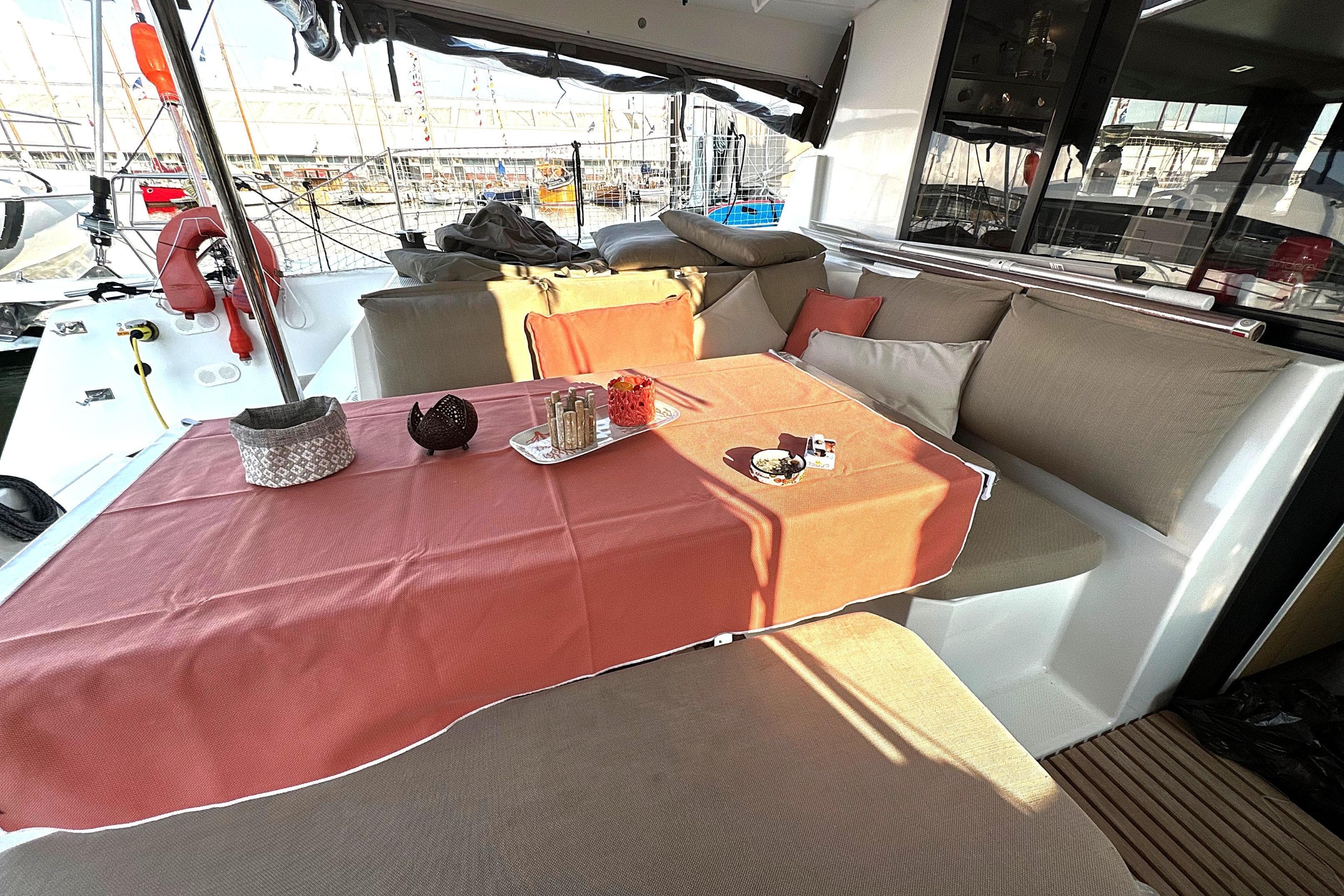 2019 Fountaine Pajot Astrea 42 Catamaran interior with cozy seating and table setup.