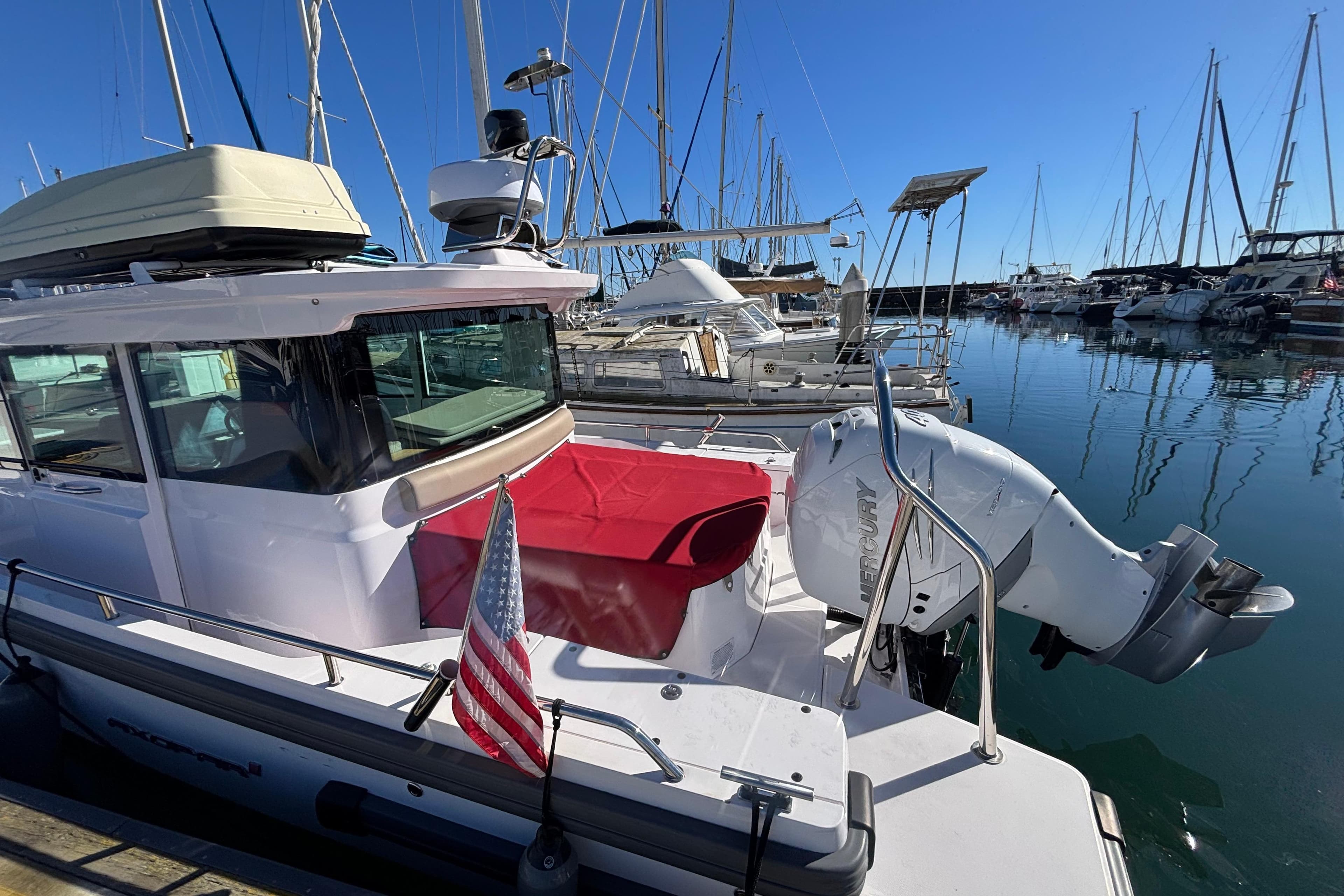 2022 Axopar 28 AFT CABIN boat docked in marina with American flag.