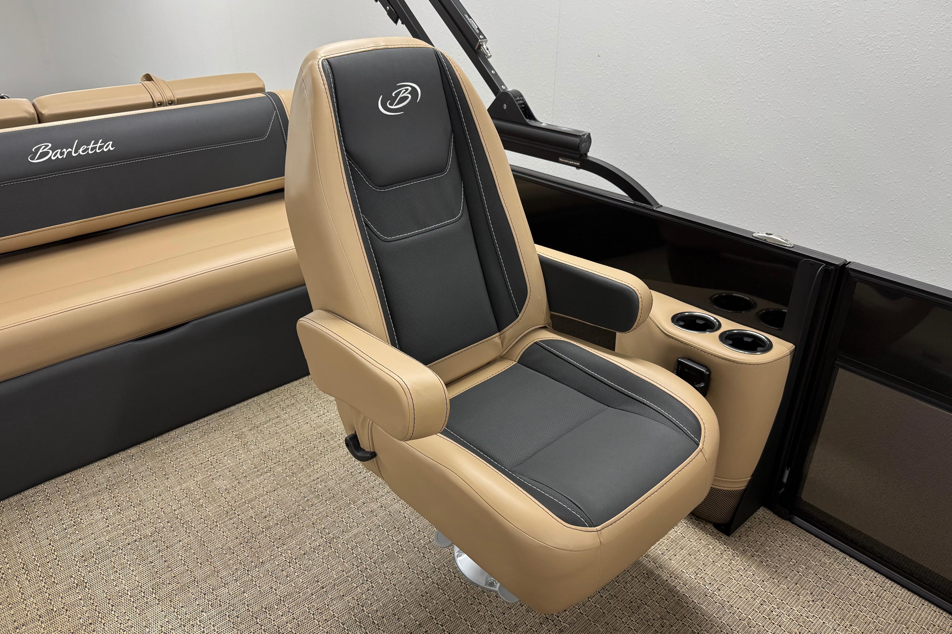 Luxurious seating in 2026 Barletta Cabrio 24UC boat, featuring tan and black upholstery.